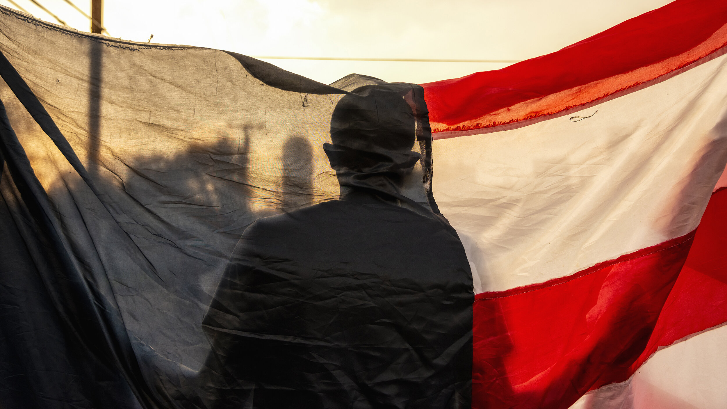  Cloaked in a starless American flag, a protester marches toward City Hall in Dallas, TX on June 7, 2020. 