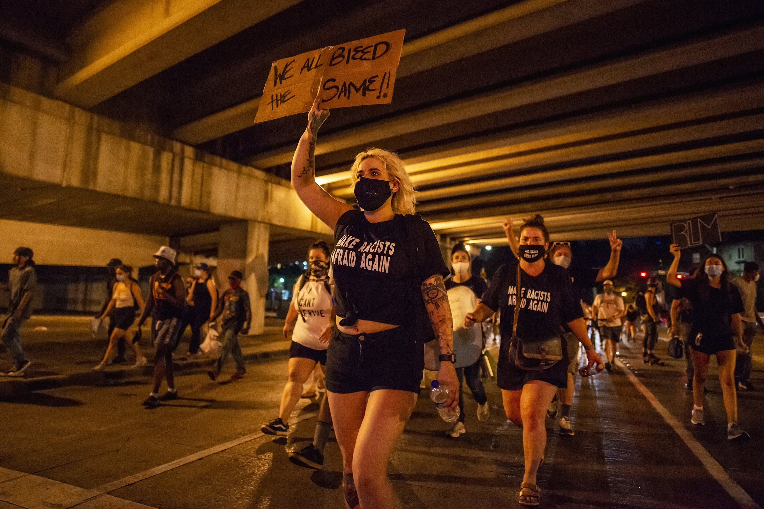  Protesters on Routh Street pass under Woodall Rodgers Freeway in Dallas, TX on June 7, 2020.  With echoes abounding, protest chants often intensified beneath bridges. 