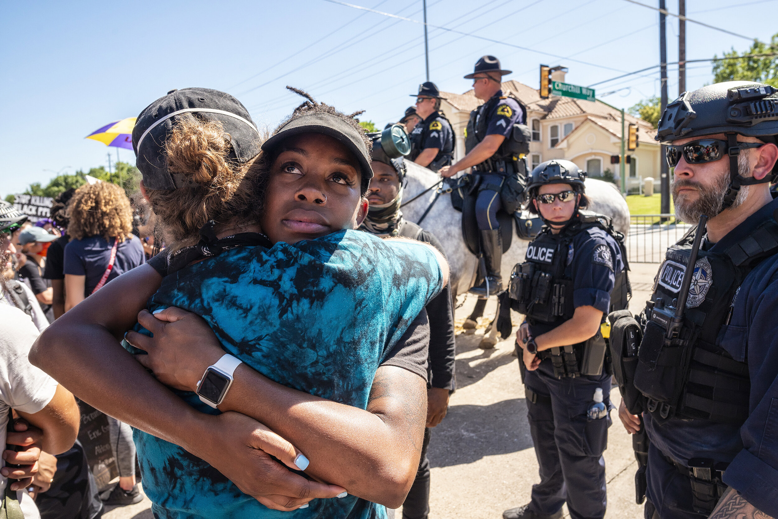  Protesters embrace at Hillcrest Road and Churchill Way ahead of President Donald Trump’s visit to Gateway Church in the Preston Hollow neighborhood of Dallas, TX on June 11, 2020.  Under heavy security, the protest remained peaceful. 