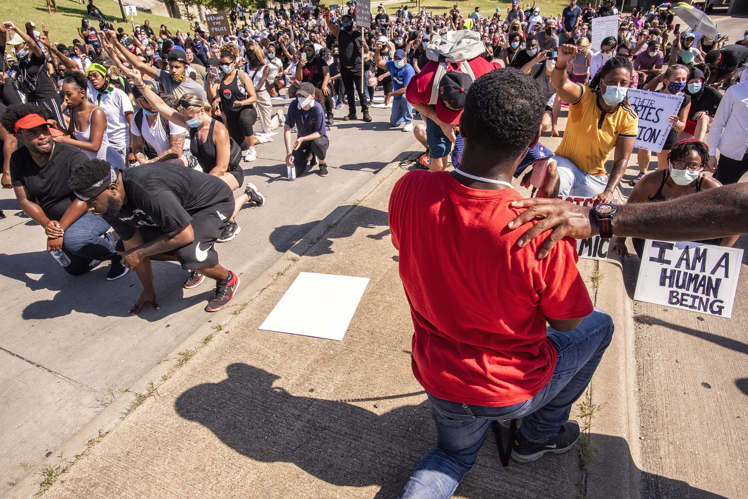  Activist Dominique Alexander takes a knee with protest marchers during the Black State of Emergency protest in Dallas, TX on June 13, 2020.  Alexander, president and founder of the Next Generation Action Network, a social justice organization, kneel