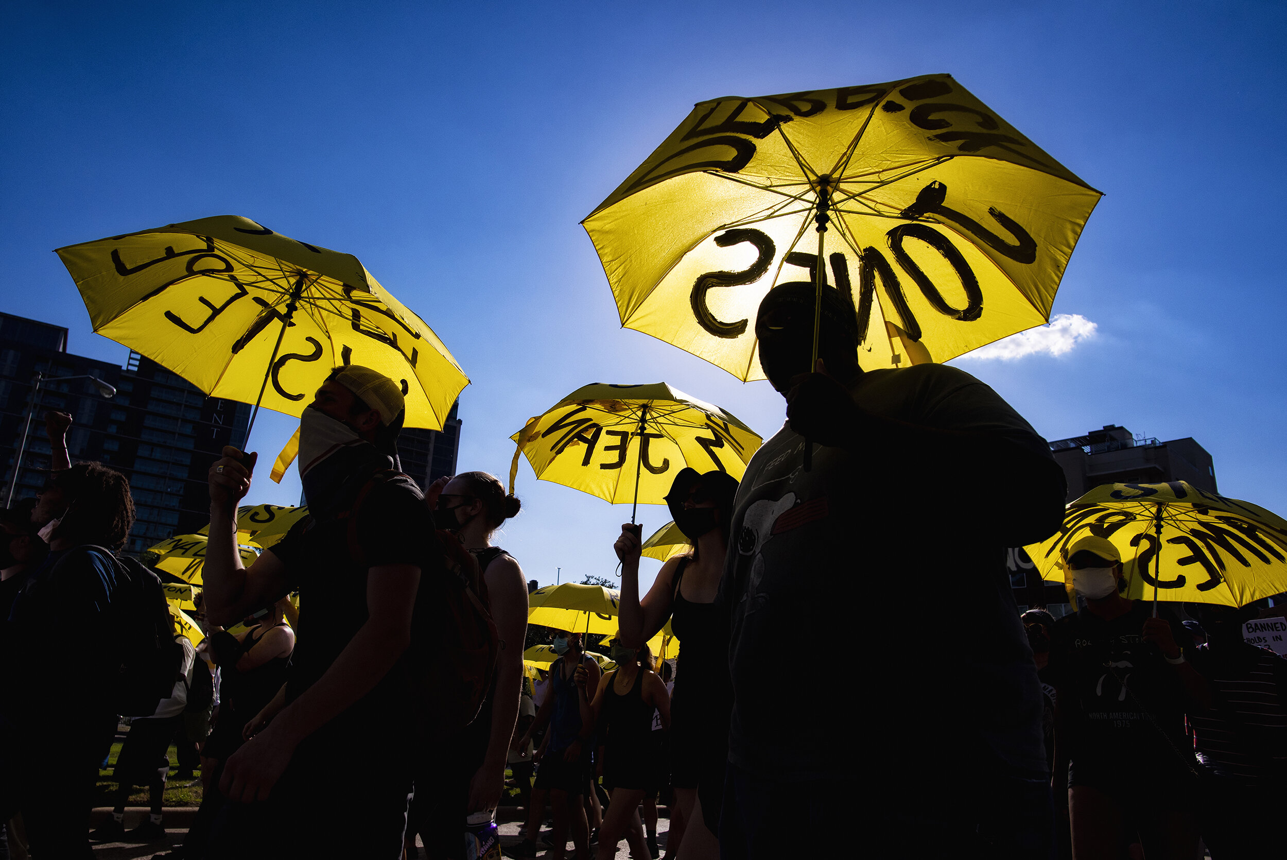  Protesters march down Harry Hines Boulevard from Pike Park in the Stop Police Crimes protest in Dallas, TX on June 13, 2020.  In a show of solidarity nodding to 2014’s Umbrella Movement in Hong Kong, Dallas artists painted yellow umbrellas with the 