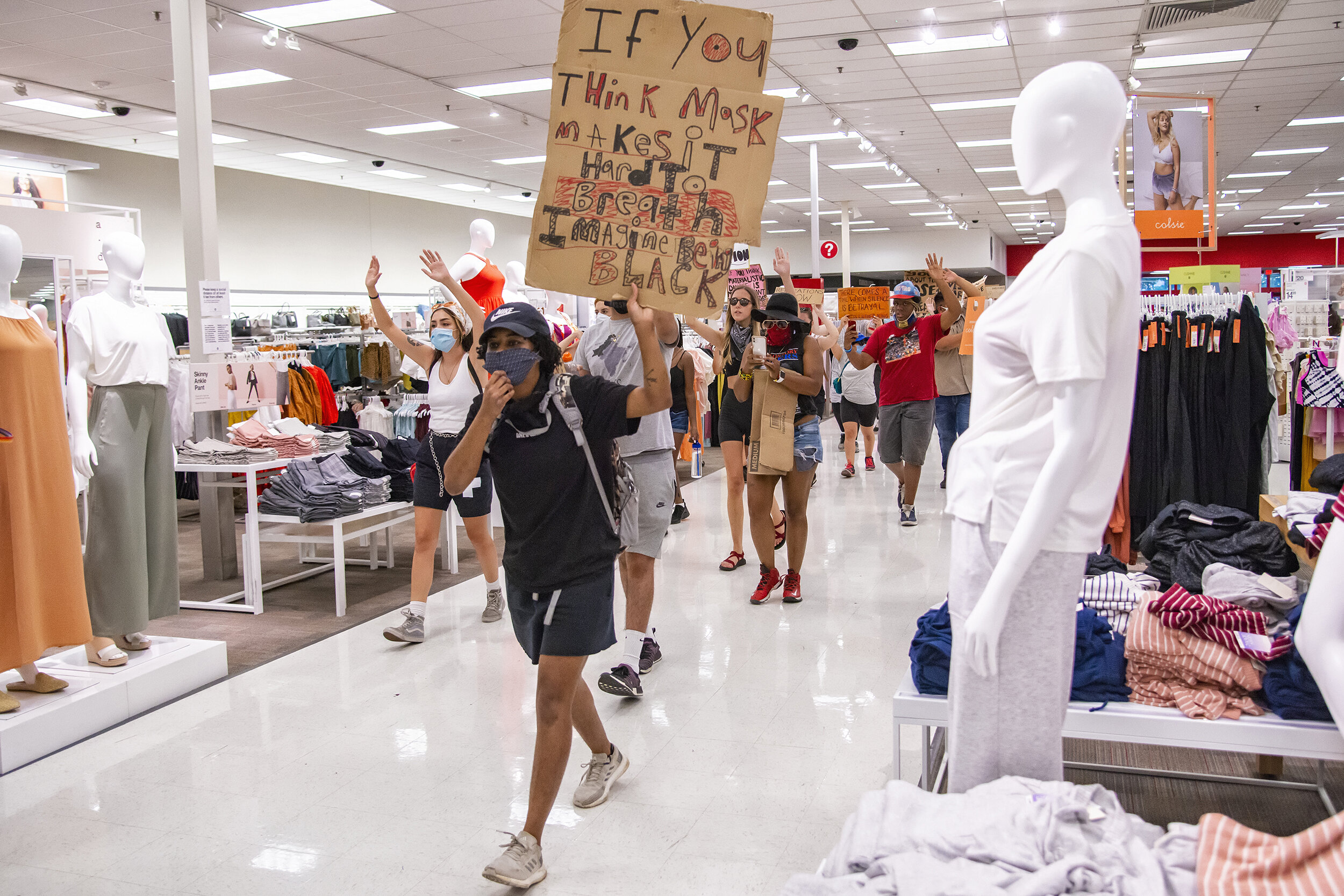 Protesters march through a Target store on Haskell Avenue in Dallas, TX on June 13, 2020.    To the shock of customers and employees, the protesters lapped the store chanting, “Hands up, don’t shoot!” before regrouping outside and carrying on withou