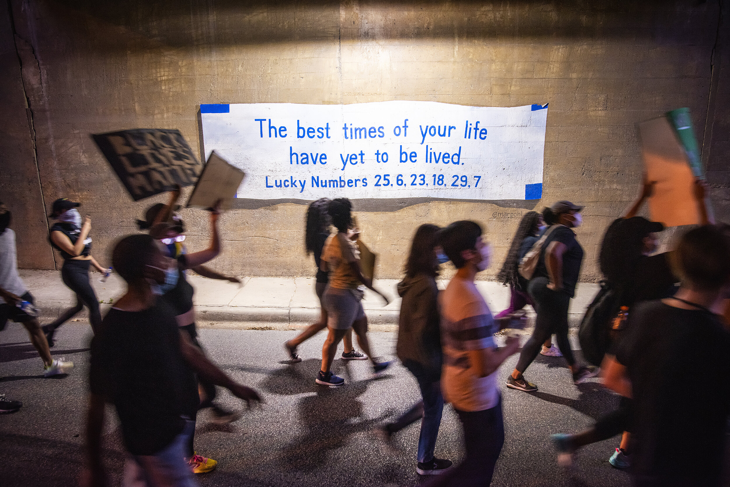  Protesters pass a mural in the Turtle Creek neighborhood of Dallas, TX on June 13, 2020.  Anti-police brutality protests first sparked off in downtown Dallas but soon spread into the city’s wealthier neighborhoods. 