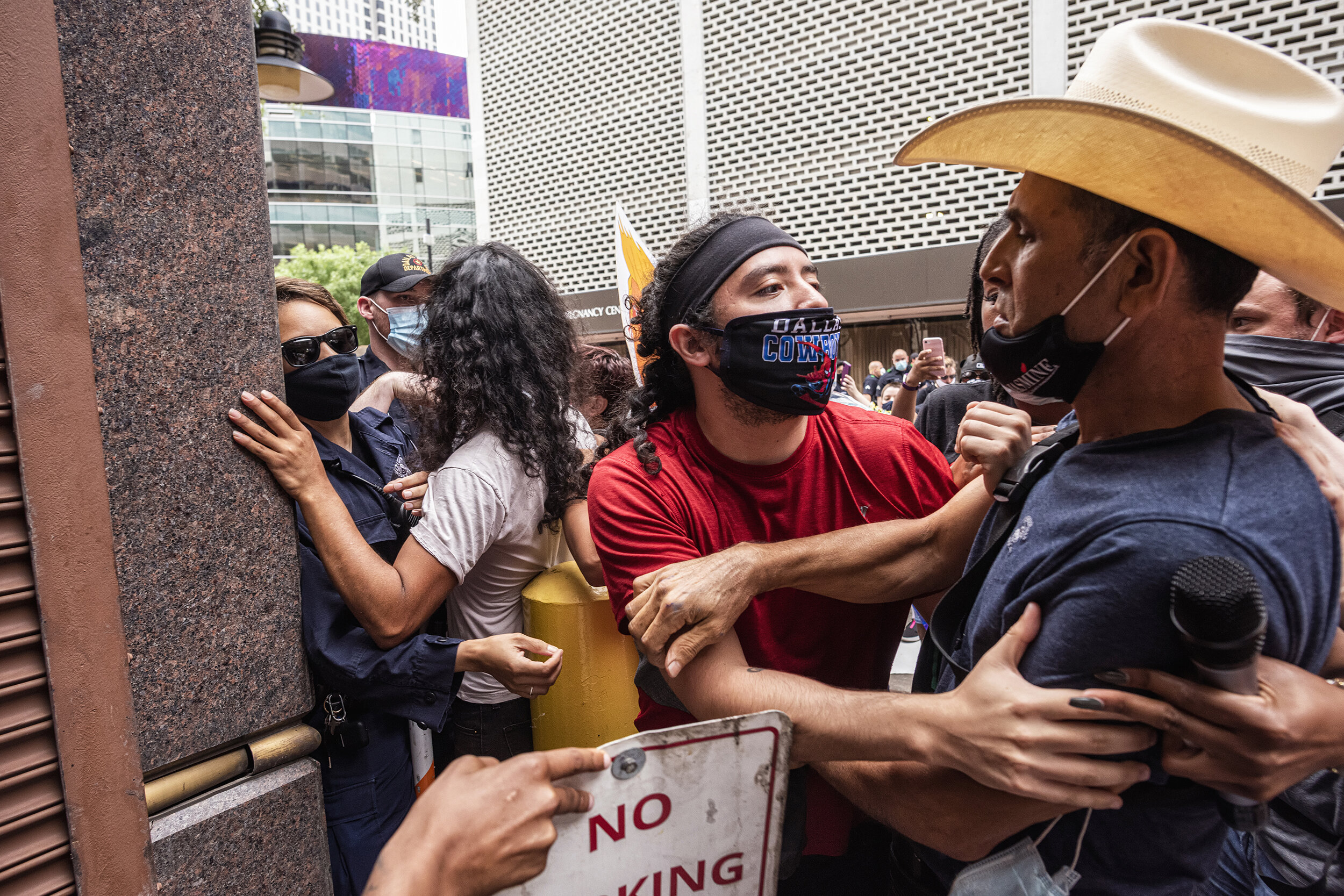  Protesters intervene when a scuffle erupts between a protester and a Dallas police officer at the Coming Out for Pence protest in downtown Dallas on June 28, 2020.  Groups including LGBTQ advocates protested a visit by Vice President Mike Pence to n