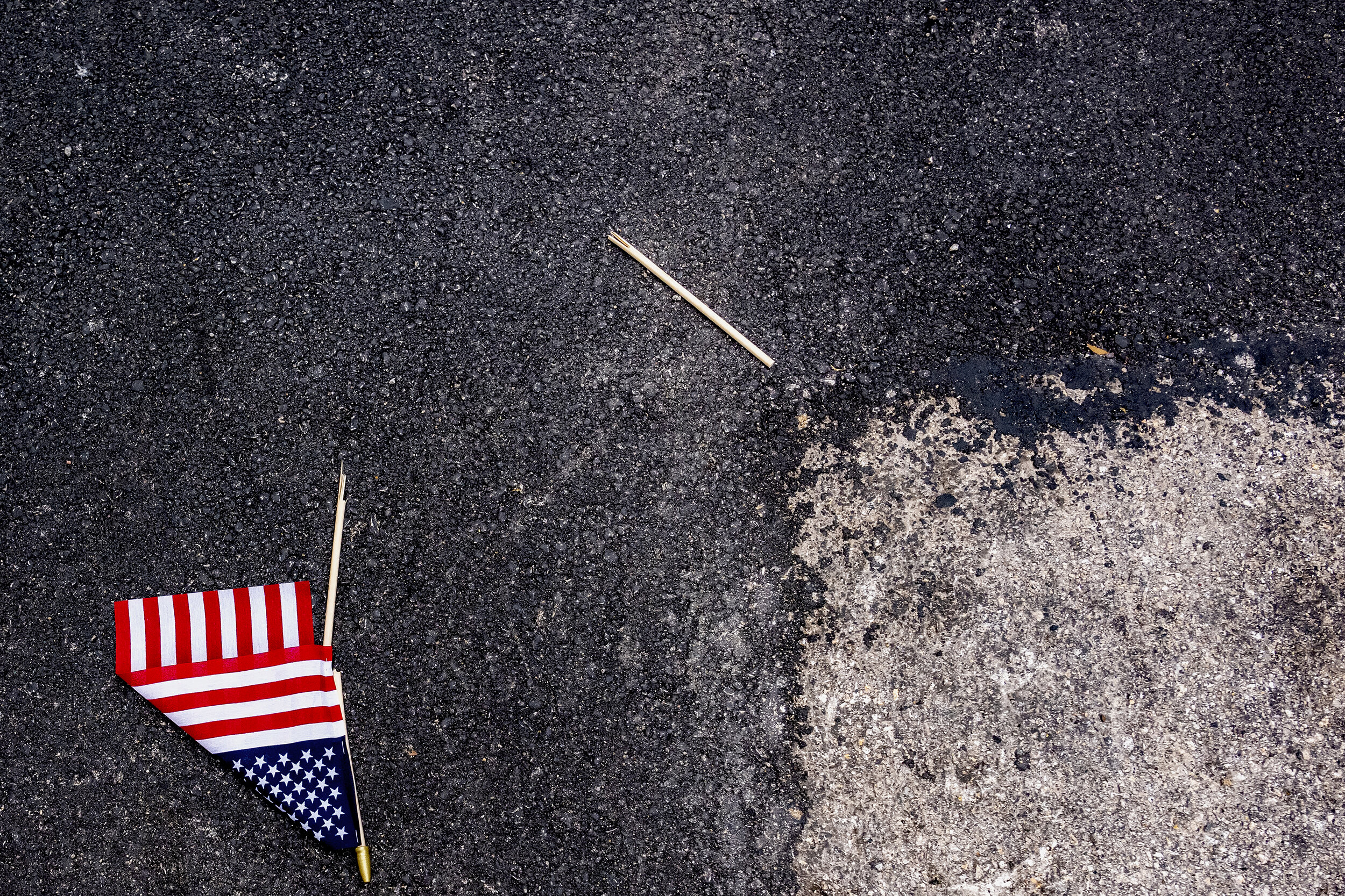  A broken American flag lies on the street in downtown Dallas, TX on June 28, 2020.  Parishioners attending a service with Vice President Pence at First Baptist Church filed out with small American flags. At least one was soon discarded. 