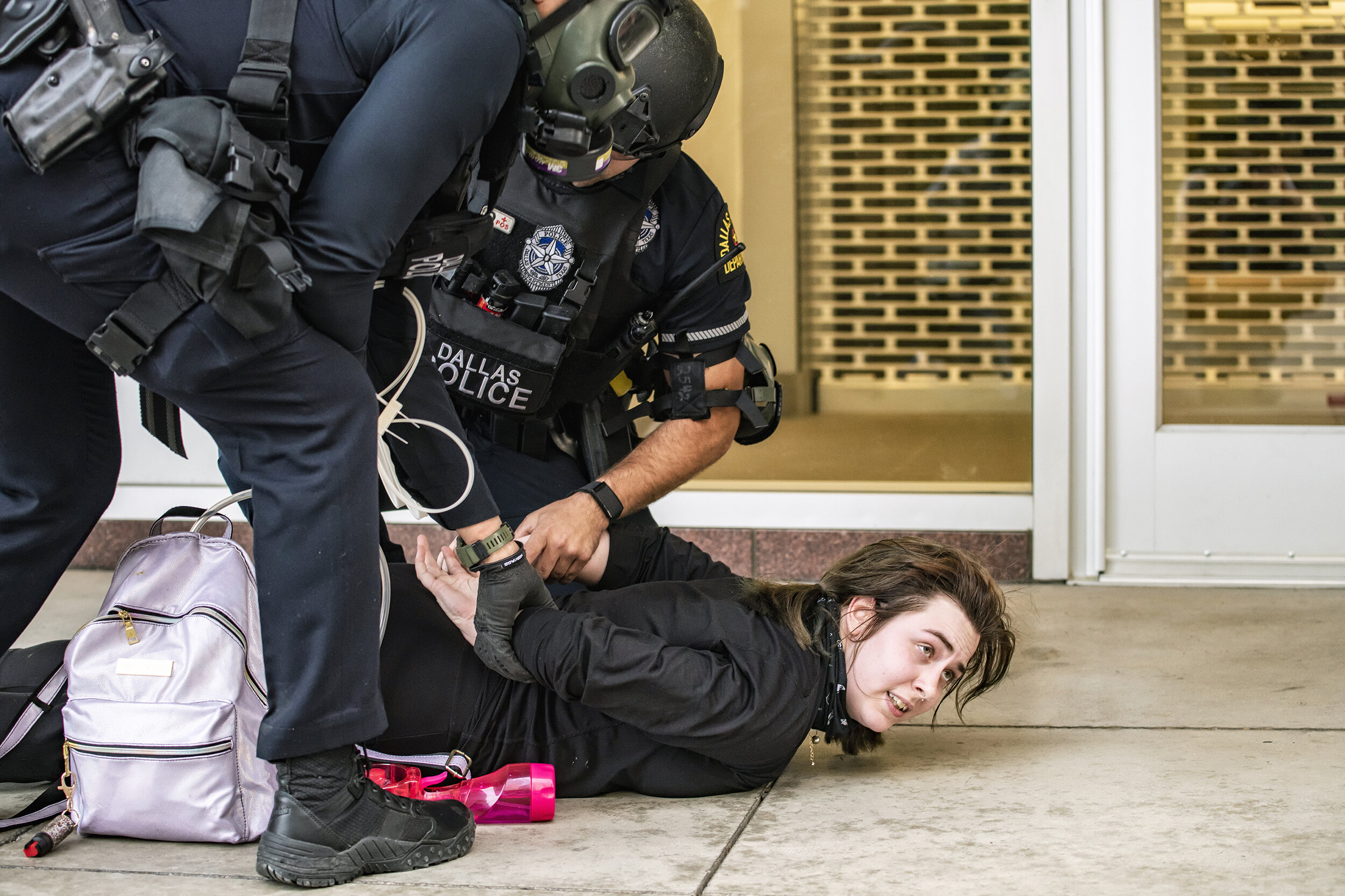  A protester is zip-tied by Dallas police in the 300 block of North St. Paul Street in downtown Dallas, TX on May 31, 2020.   Despite a peaceful protest march, once the 7 p.m. curfew commenced, police fired chemical agents into some crowds before mak