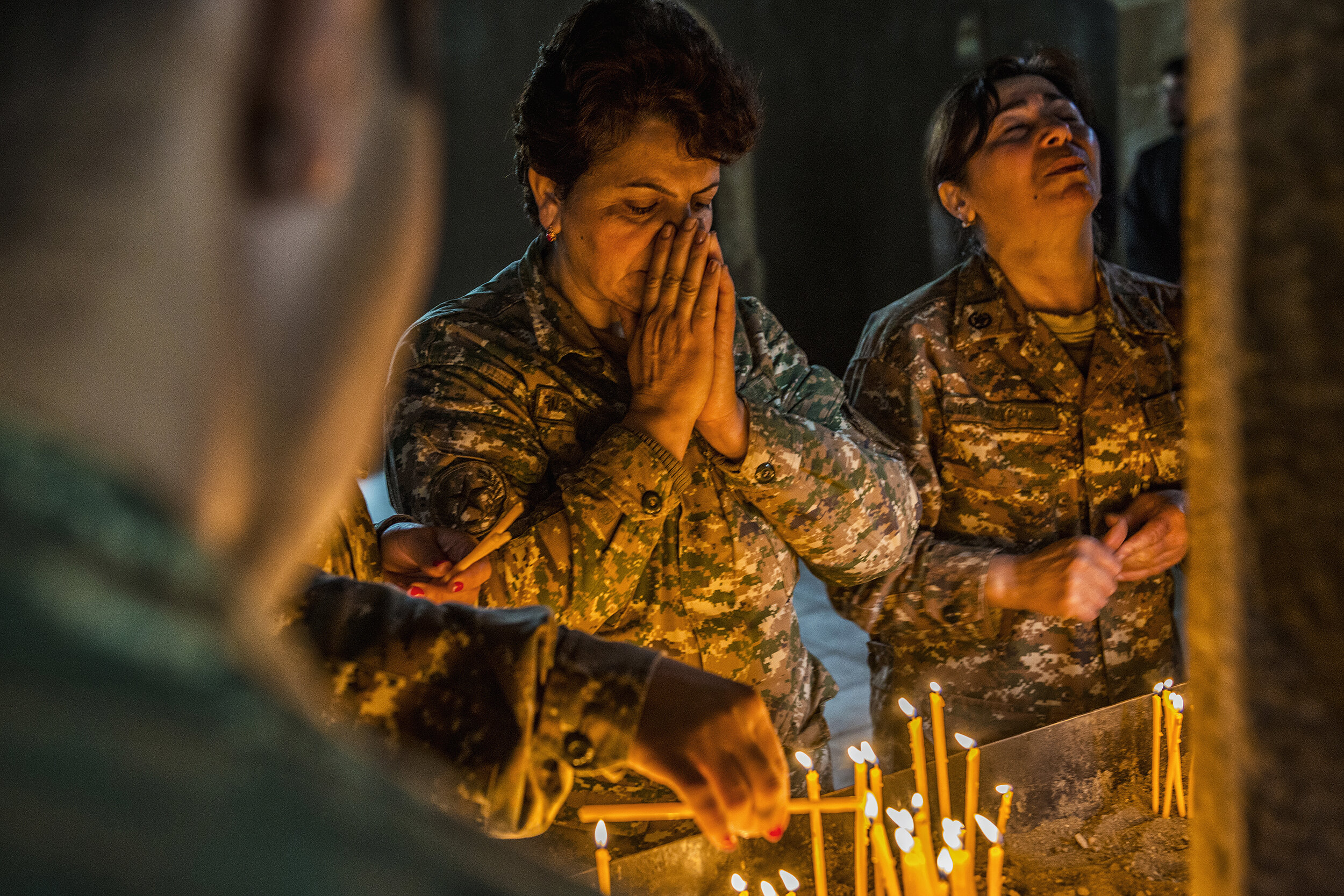  NKR soldiers pray in the ancient Church of Mother Mary near the Line of Contact in Talish, Nagorno-Karabakh.  The NKR was 95% ethnic Armenian, their ancestors having adopted Christianity in 301 A.D.  Female soldiers did not traditionally engage in f