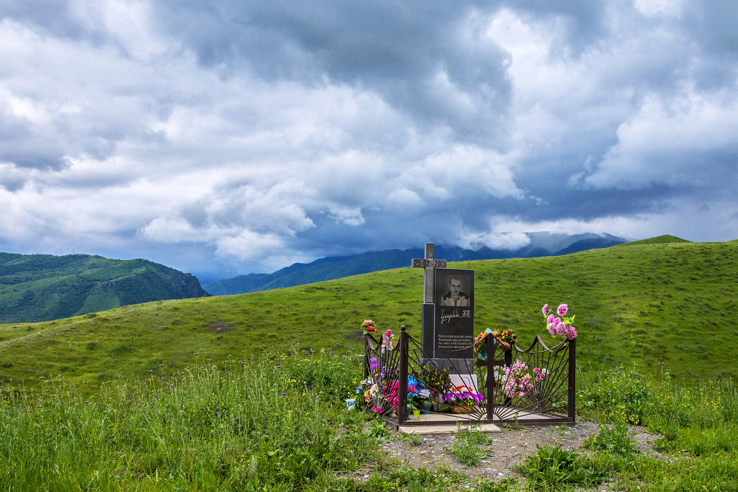  Near the Line of Contact in Mataghis, Nagorno-Karabakh, a memorial reads:    The mist that settled on my path  brought me eternal sleep,  and the cruel death laid hold of me,  leaving my dreams unfulfilled. 