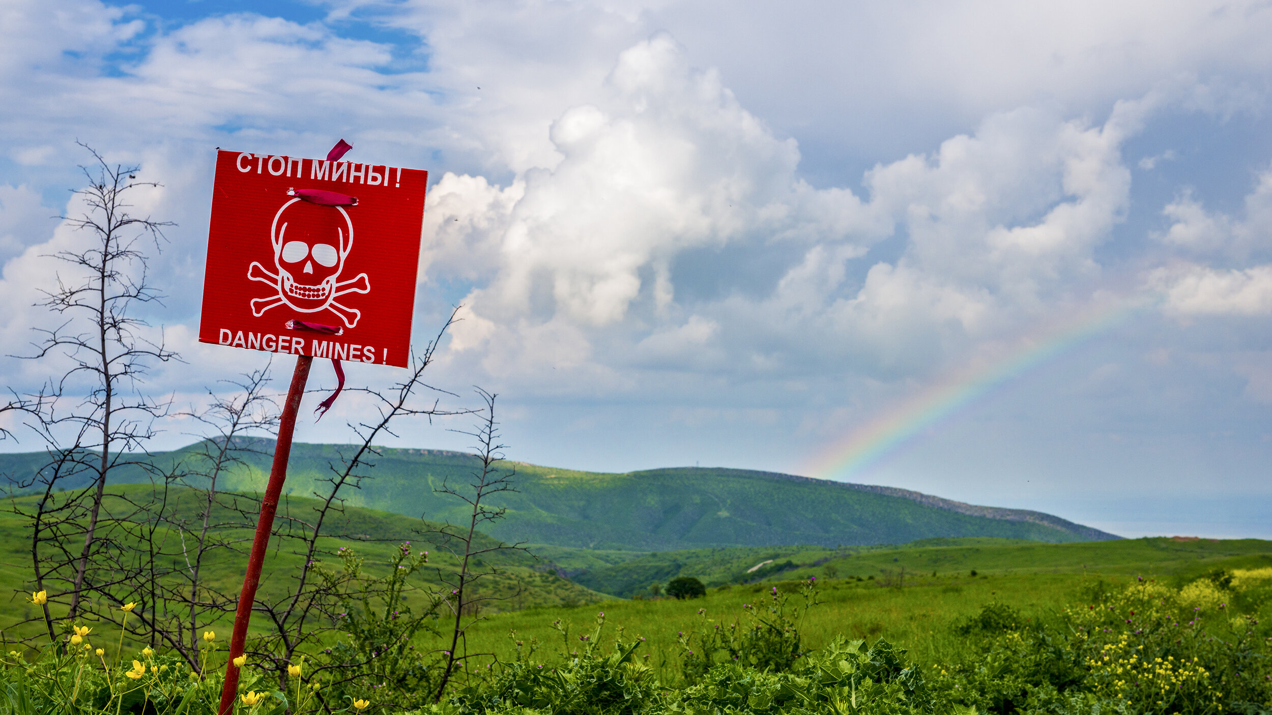 A sign in English and Russian warns of mines near Mokhratagh, Nagorno-Karabakh.  According to the HALO Trust, a U.S.-backed British de-mining nonprofit, 160mm rockets were fired into area fields during the Four-Day War.  Each rocket scattered 104 bo