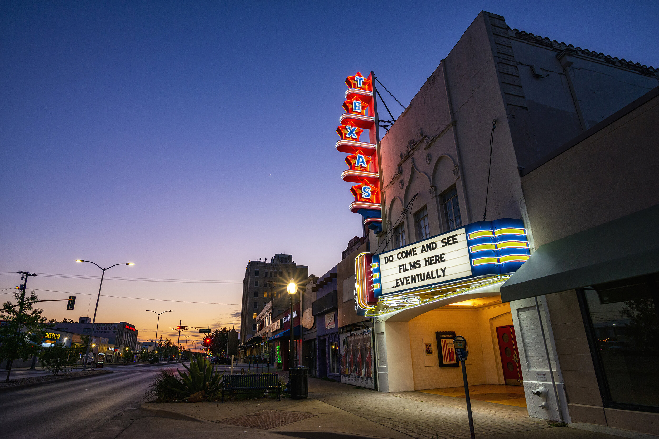  During the 2020 COVID-19 pandemic, Texas Theatre in Dallas, TX failed to host its typical din of bar patrons and moviegoers.  In May 2020, Dallas was locked down to stop the coronavirus’ spread, which failed.  The theater, opened in 1931 and once ow