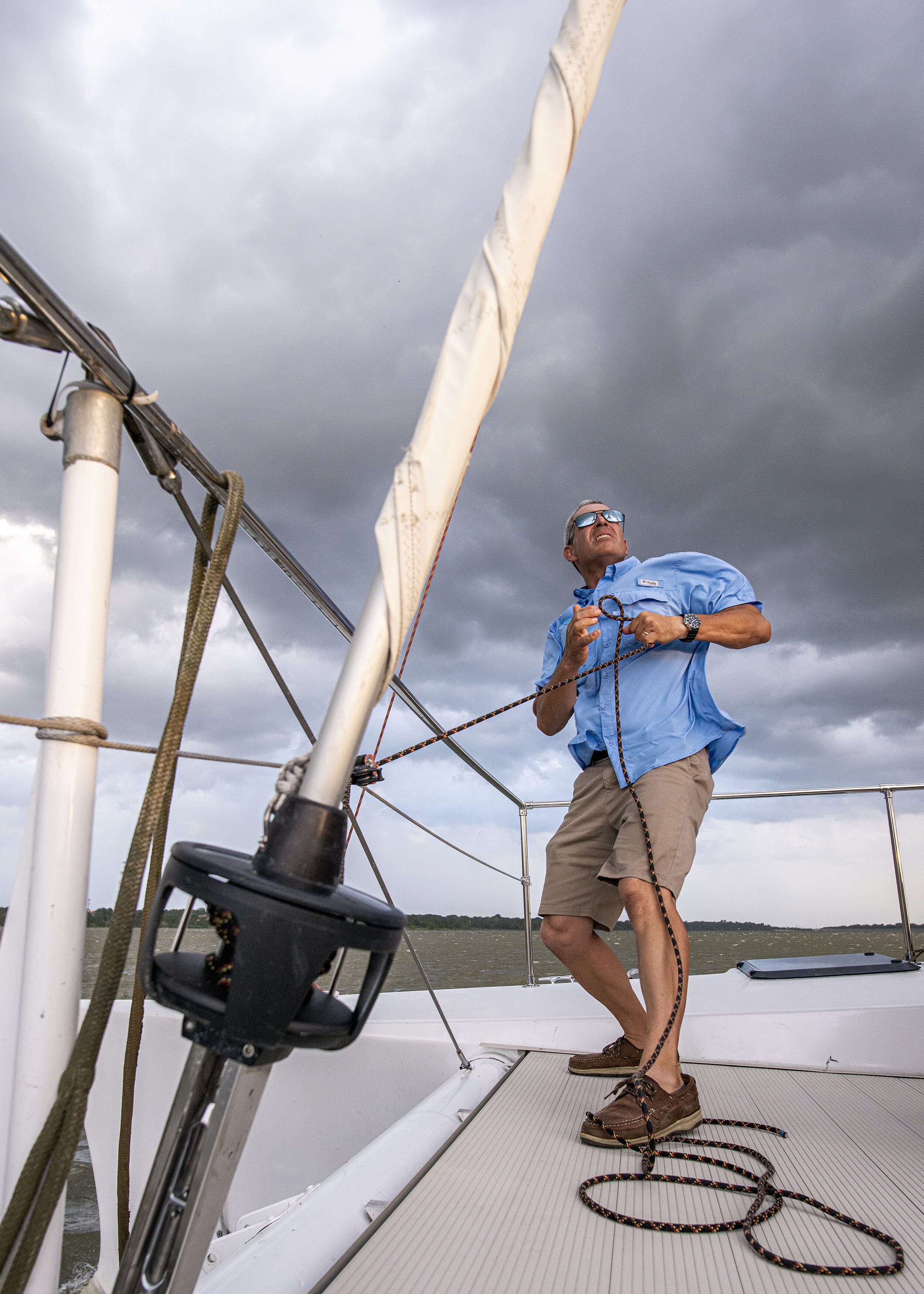  Captain Michael Mittman furls a jib sheet aboard the Spirit of Dallas on White Rock Lake in Dallas, TX.  Mittman and his wife, Greta Mittman, were competitive sailors and offered free boat rides on their 32-passenger, 38-foot-long catamaran.  “You’d