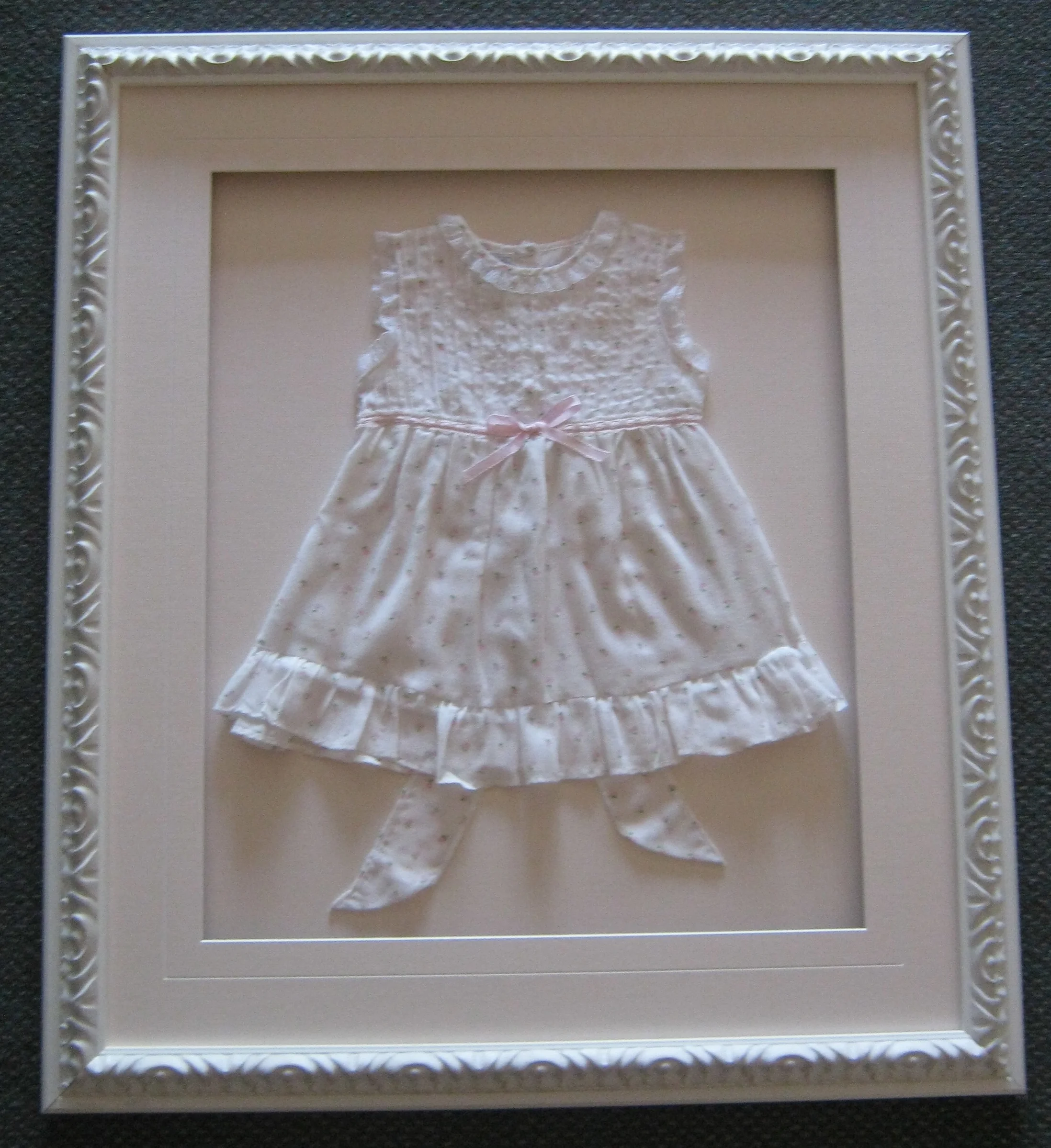 framing antique baby clothes