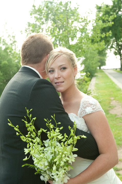 bride holding a flower bouquet and a groom