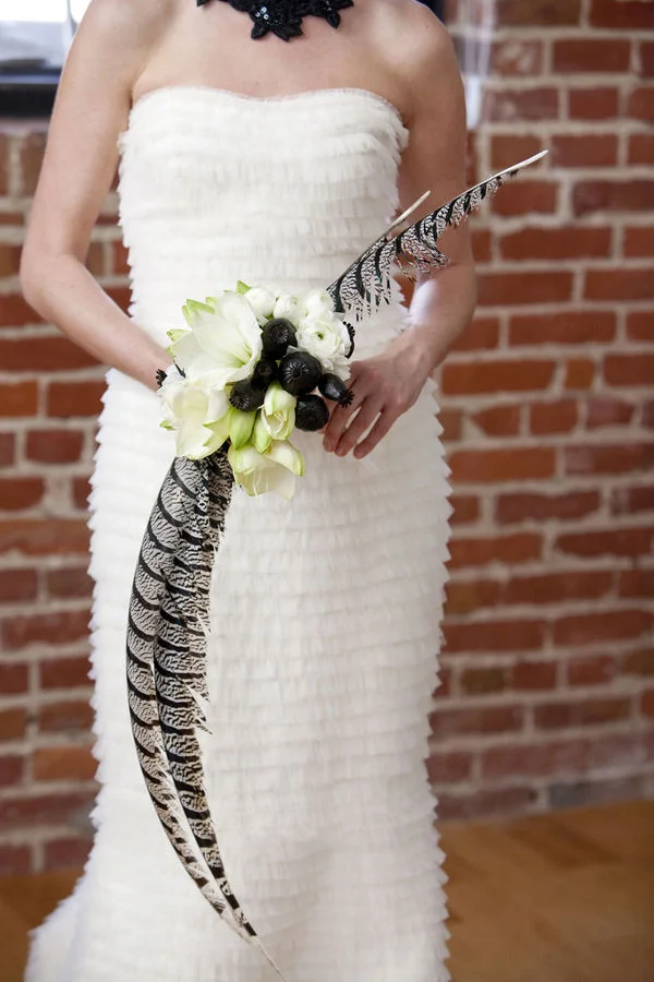 a woman with a black-white-feather-wedding-bouquet