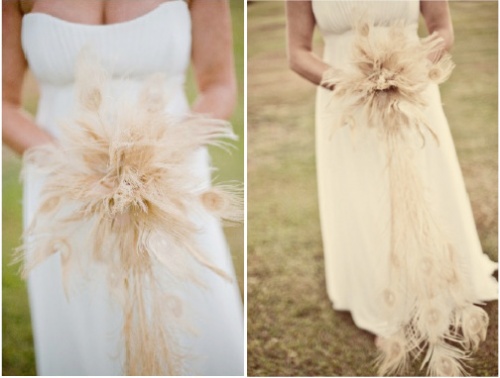bride holding a feather bouquet