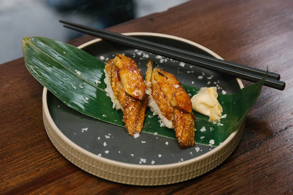The final dish, garnished with rock salt and pickled ginger on banana leaf
