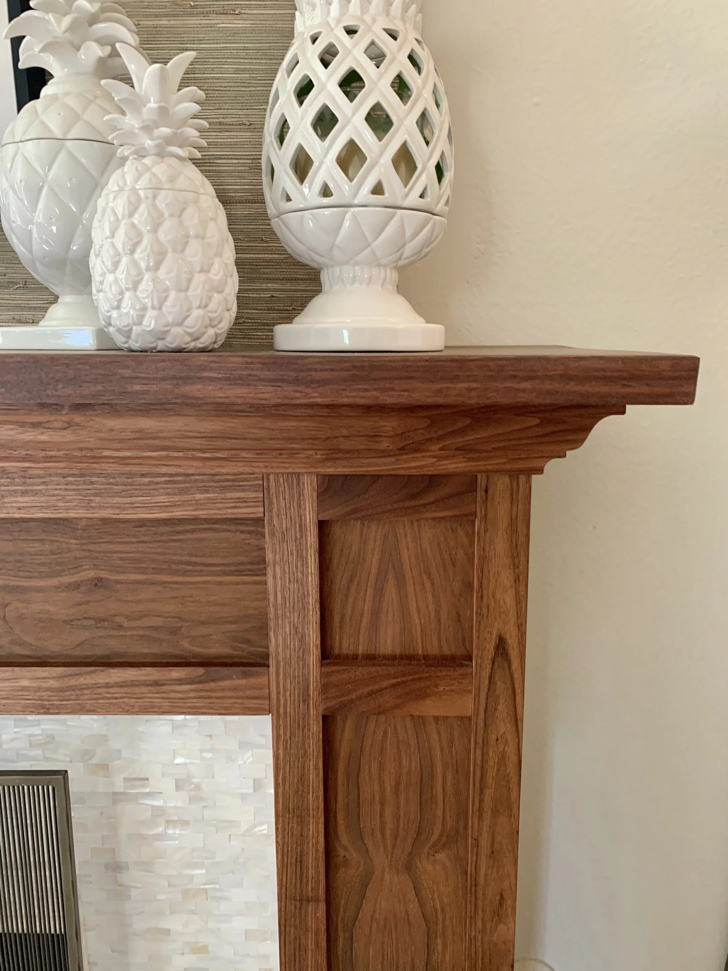 Custom fireplace mantle of walnut with mother of pearl tile