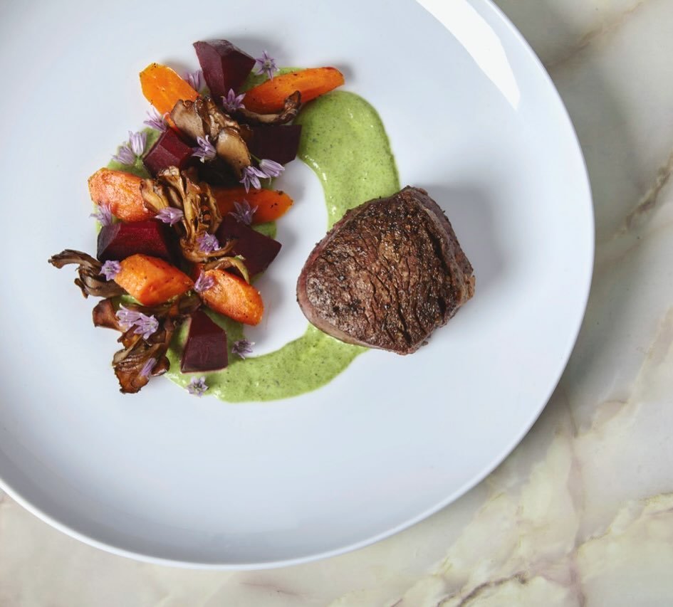 Exploring new flavor profiles and echoing these combinations throughout the plate. Coriander lemon thyme roasted beets, carrots and maitake mushrooms with filet of beef and a garlic ramp yogurt sauce garnished with chive blossoms #chefsroll #forksnro