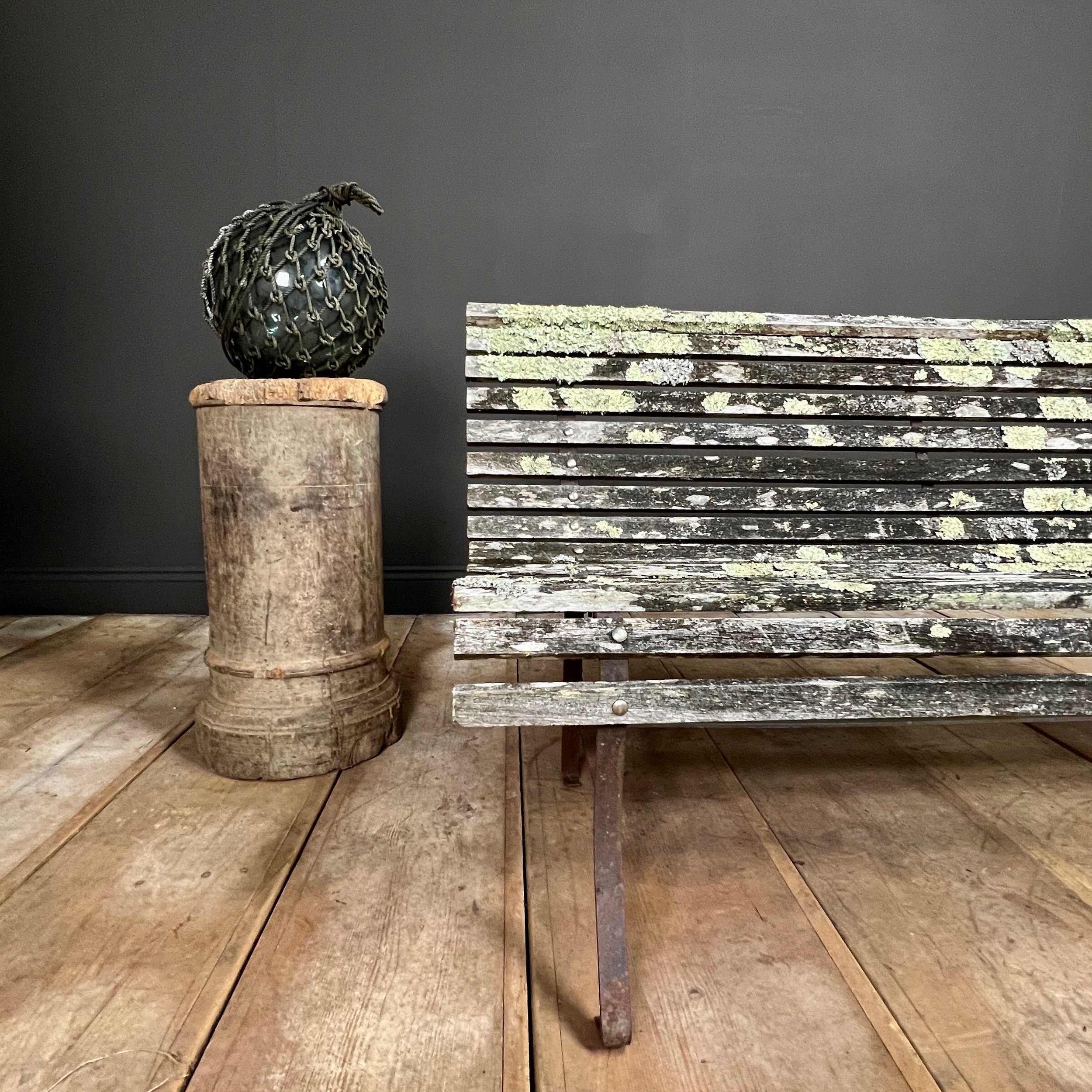 Fine example of a period scrolling garden bench wonderfully camouflaged with forest lichen