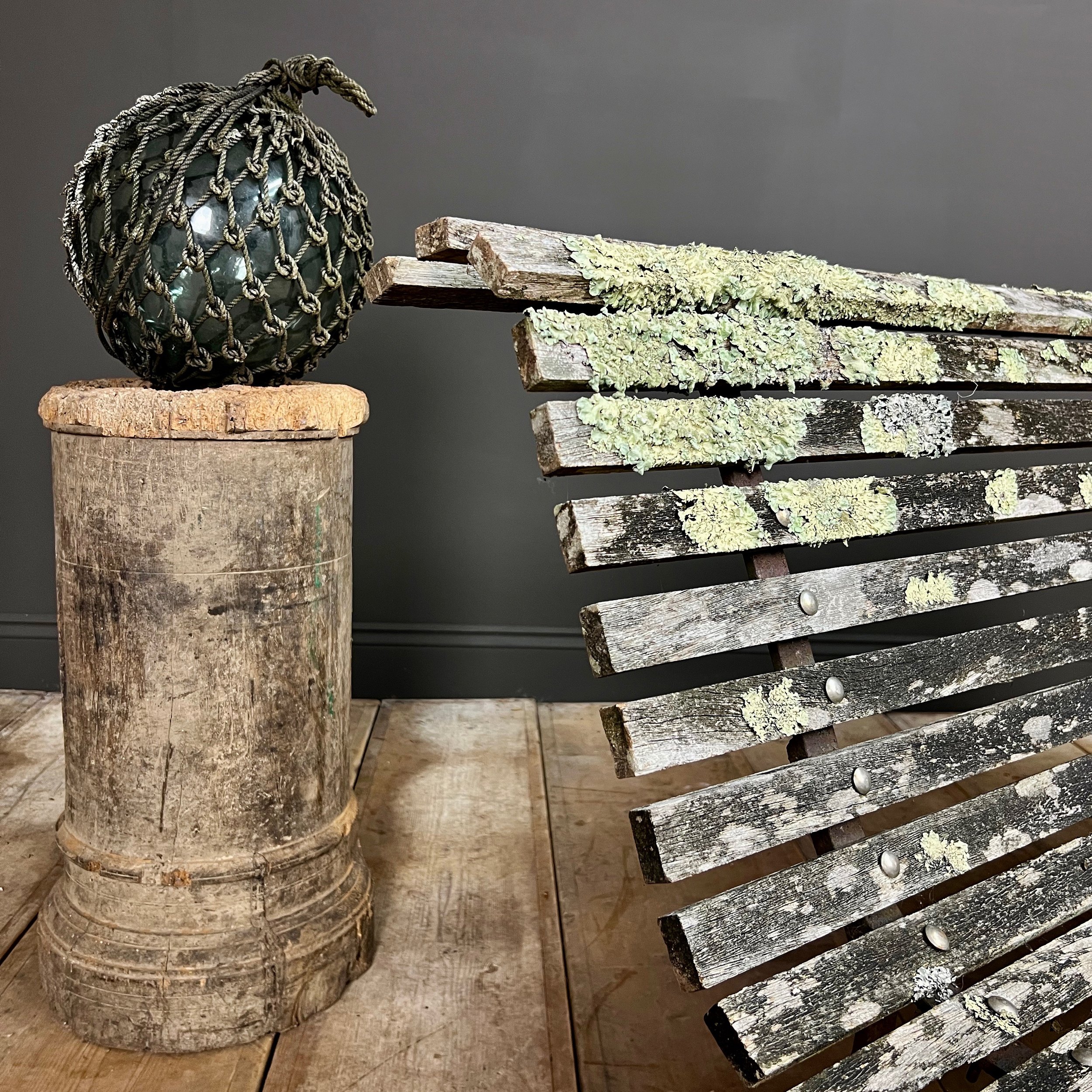 Fine example of a period scrolling garden bench wonderfully camouflaged with forest lichen