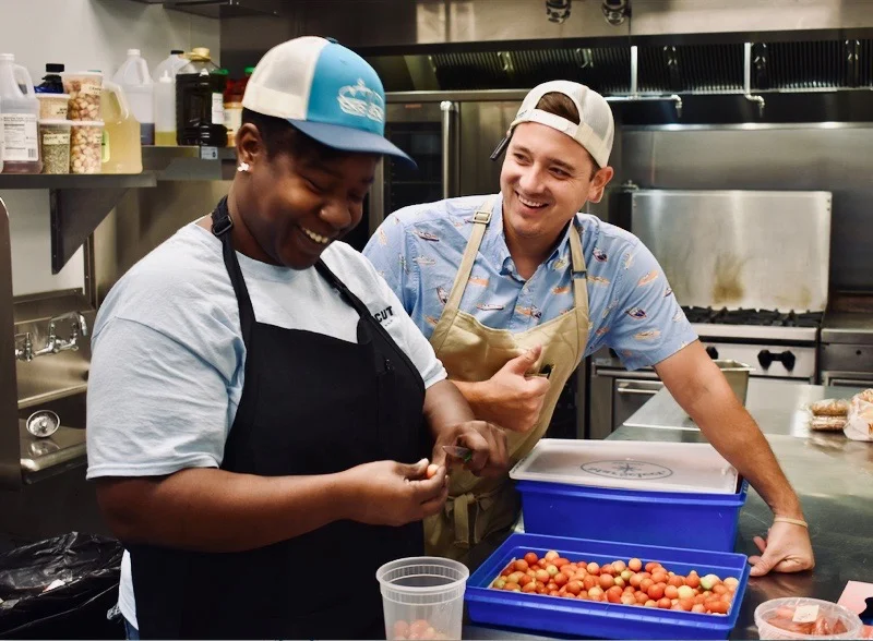 Photo : Seretha, 2018 StepUp graduate, and co-owner, Brad Bankos, behind the scenes at EastCut.