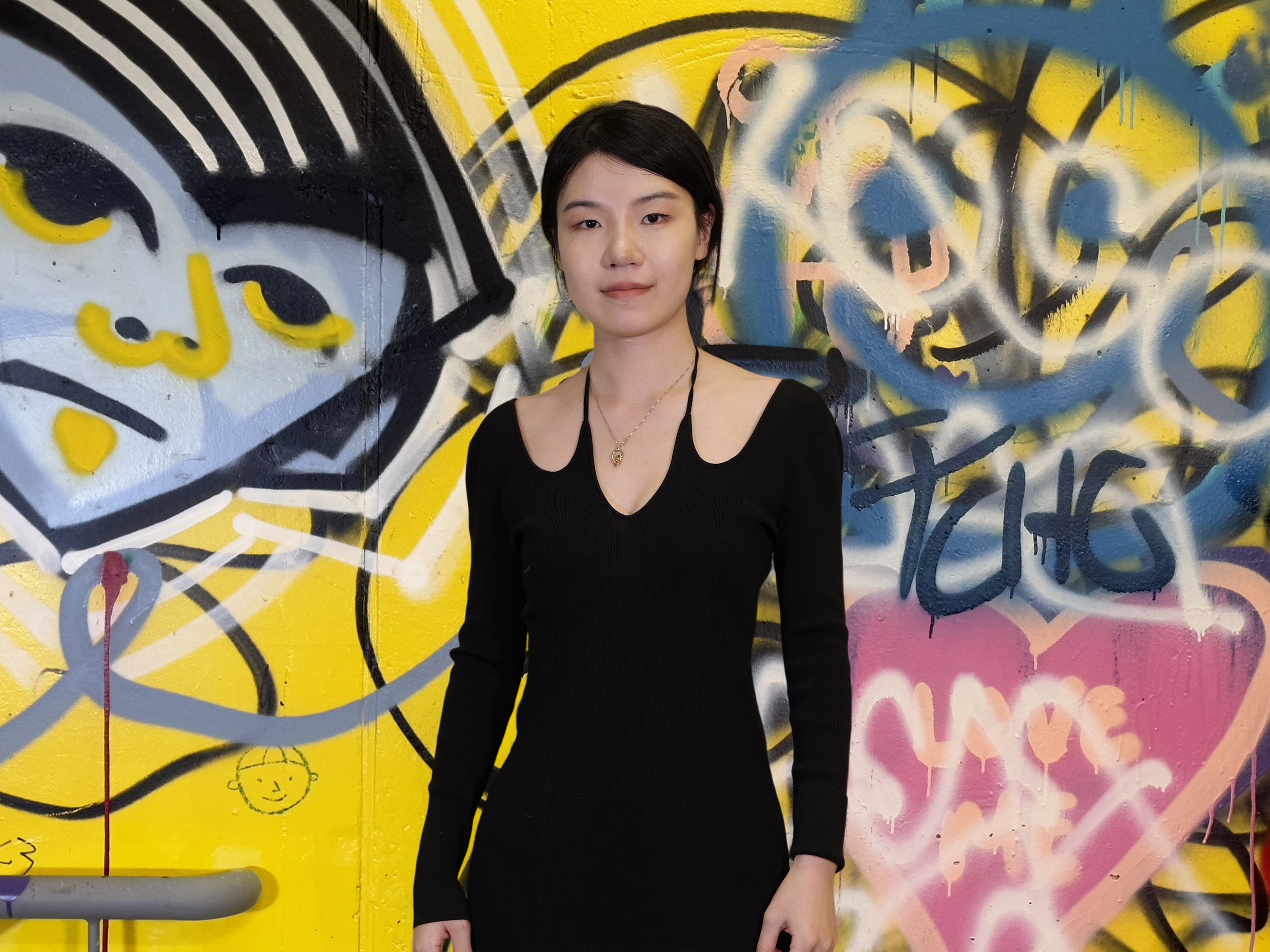 Jiamin in a graffiti hallway