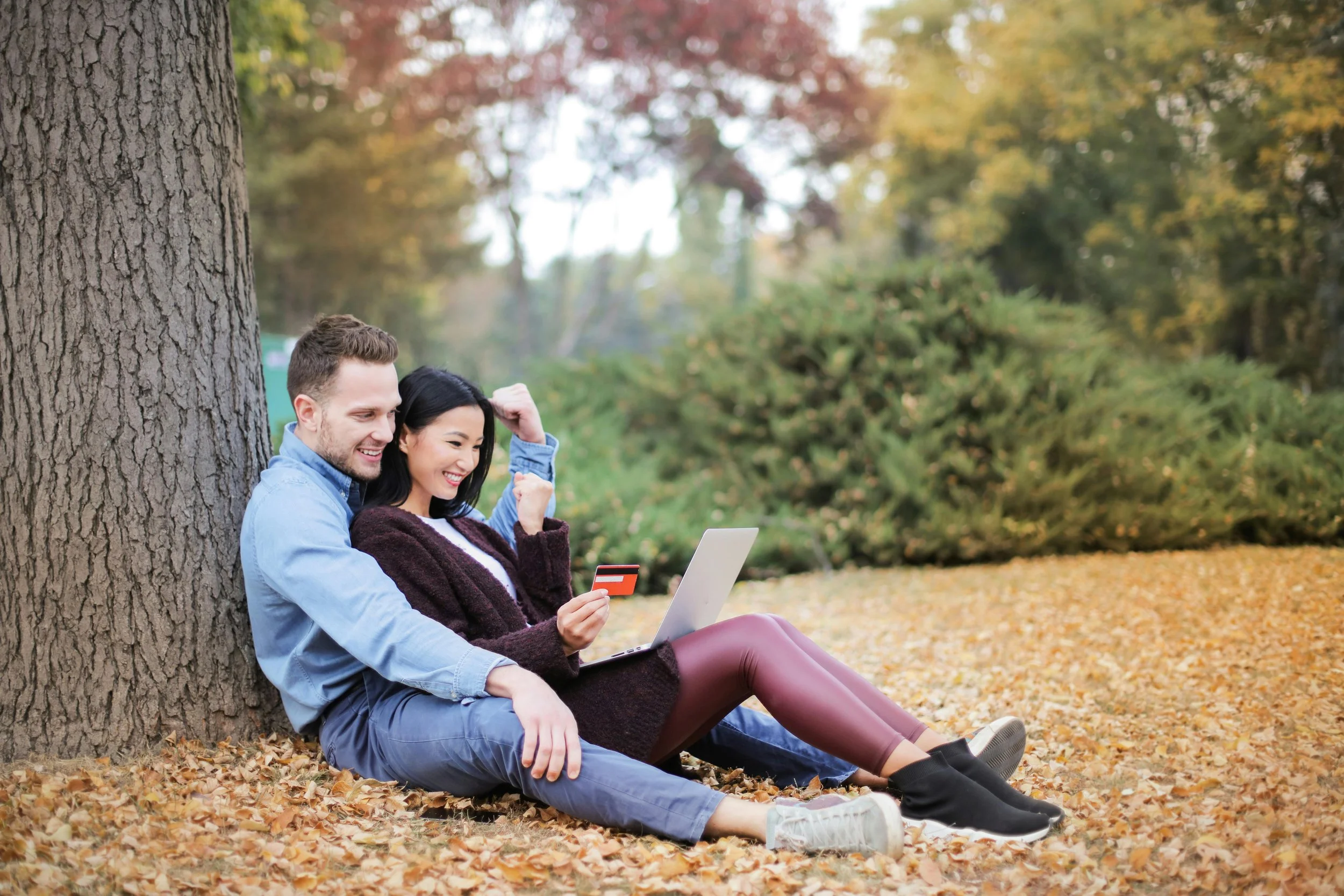 Couple sitting together against a tree outdoors — couples therapy consultation in Houston TX
