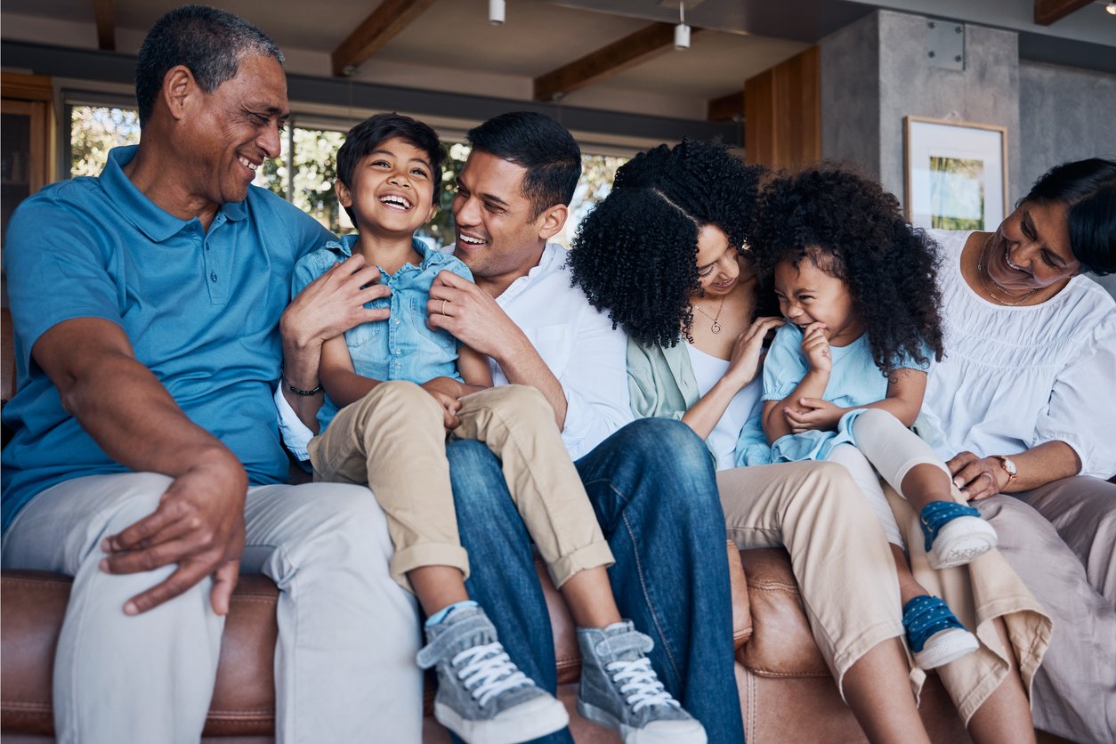 Multi-generational BIPOC family laughing together — parenting therapy in Houston TX