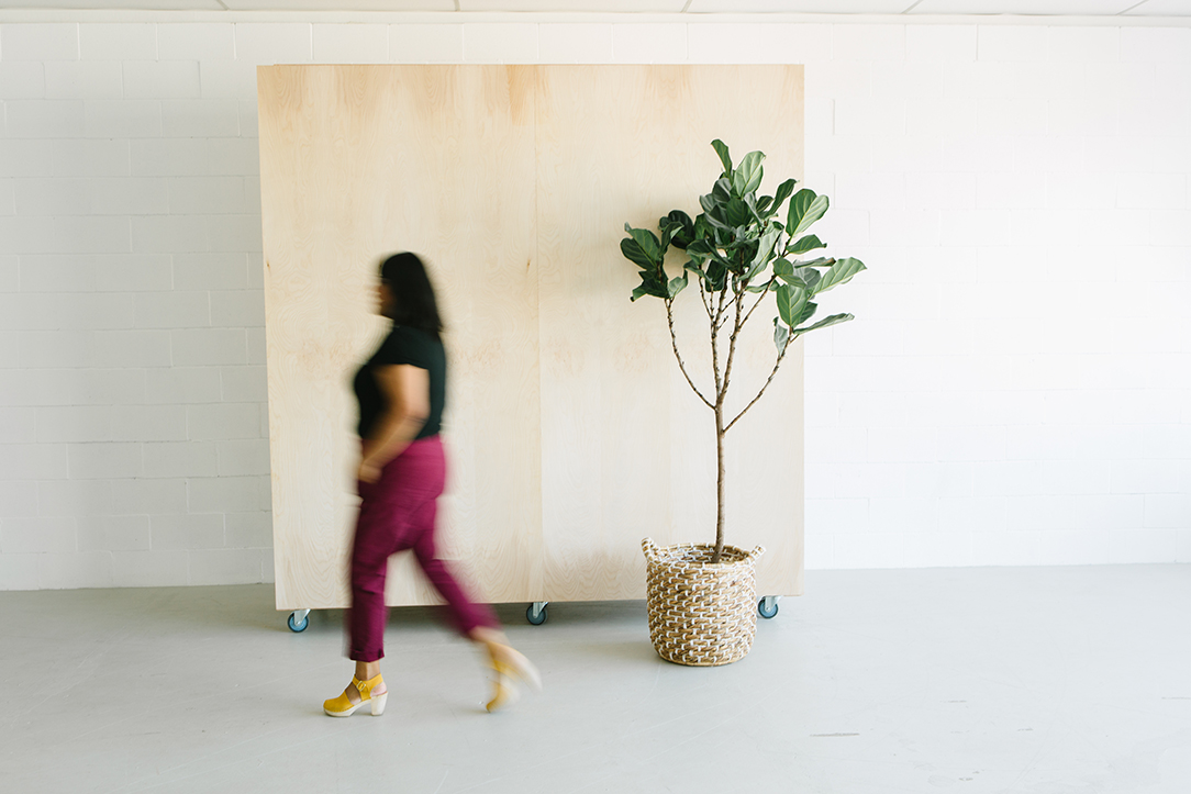 photographer walking by a backdrop in natural light studio in dublin ca.jpg