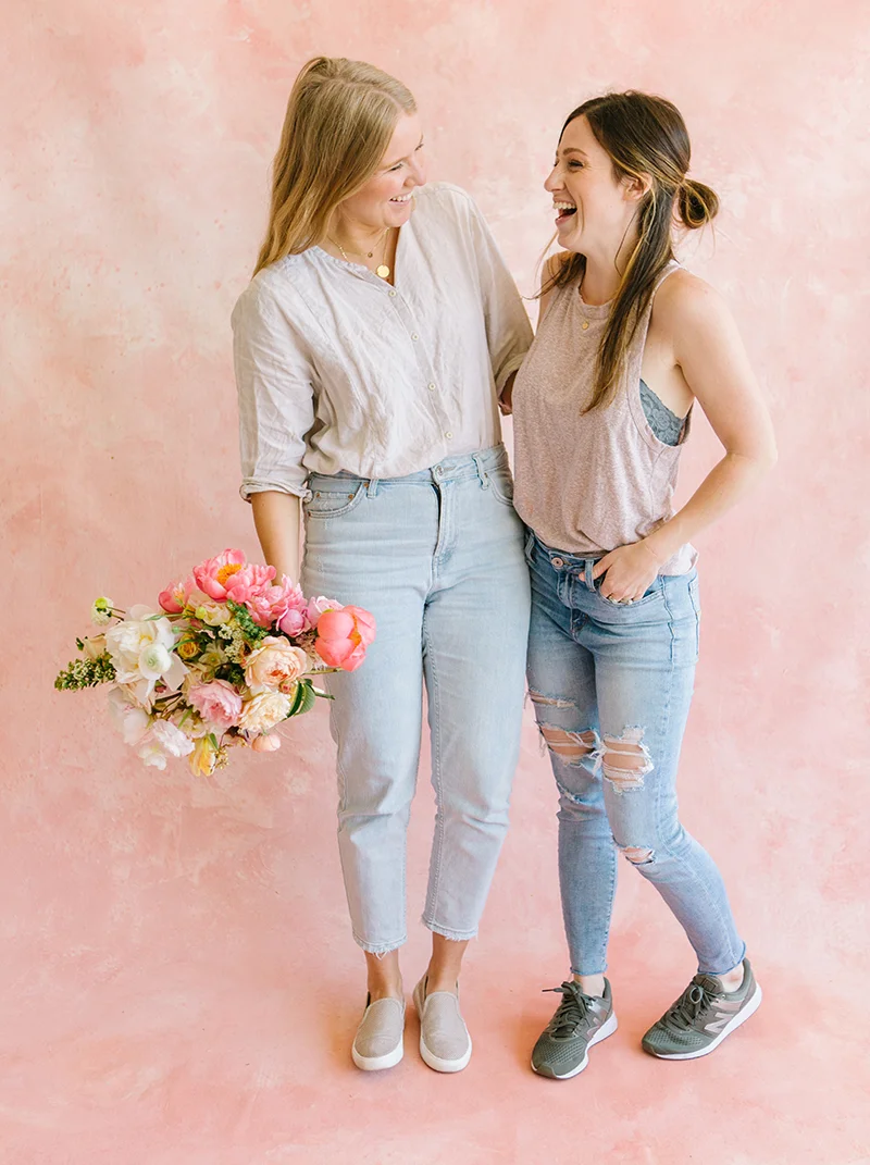 backdrop painter and florist posing in front of a custom painted backdrop in white rentable studio space in dublin ca.jpg