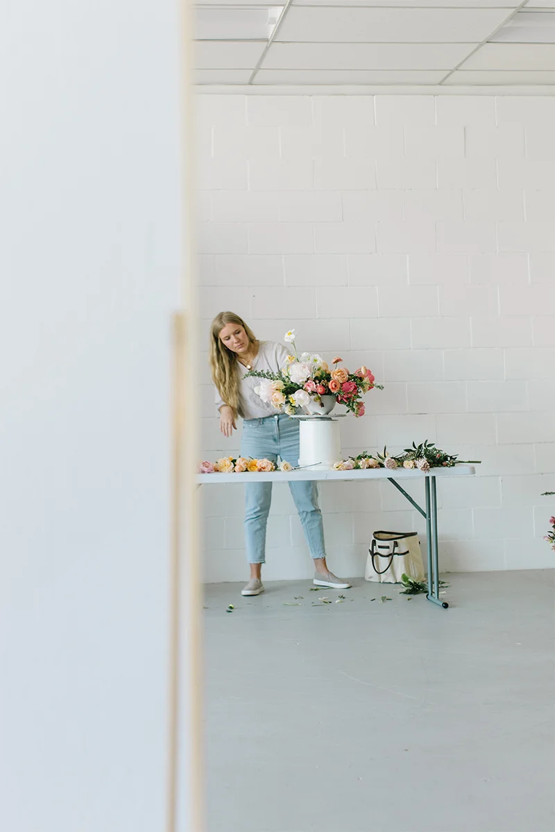 florist arranging flowers in white studio in danville ca.jpg