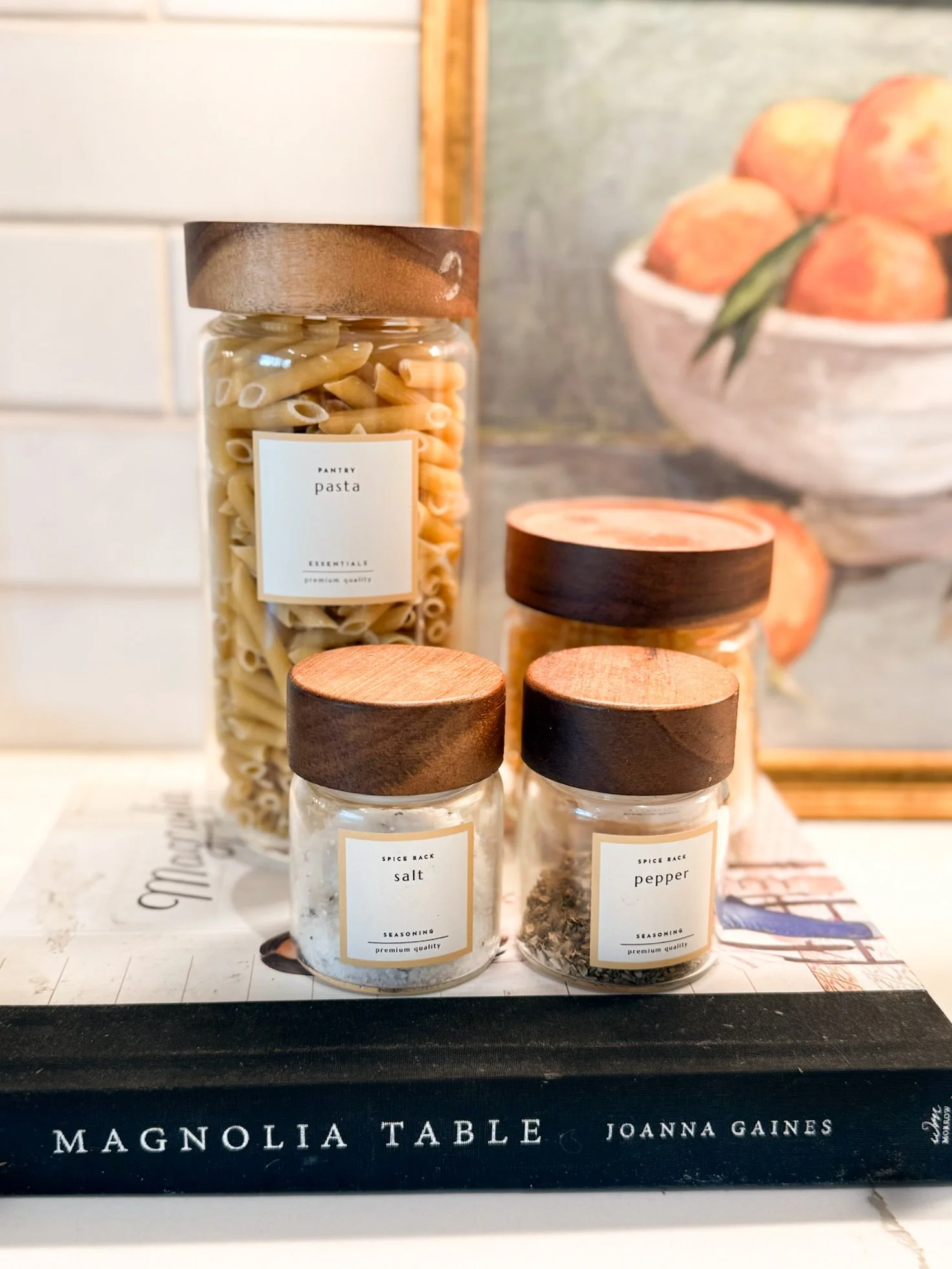 glass containers for kitchen storage of pasta, pepper, and salt
