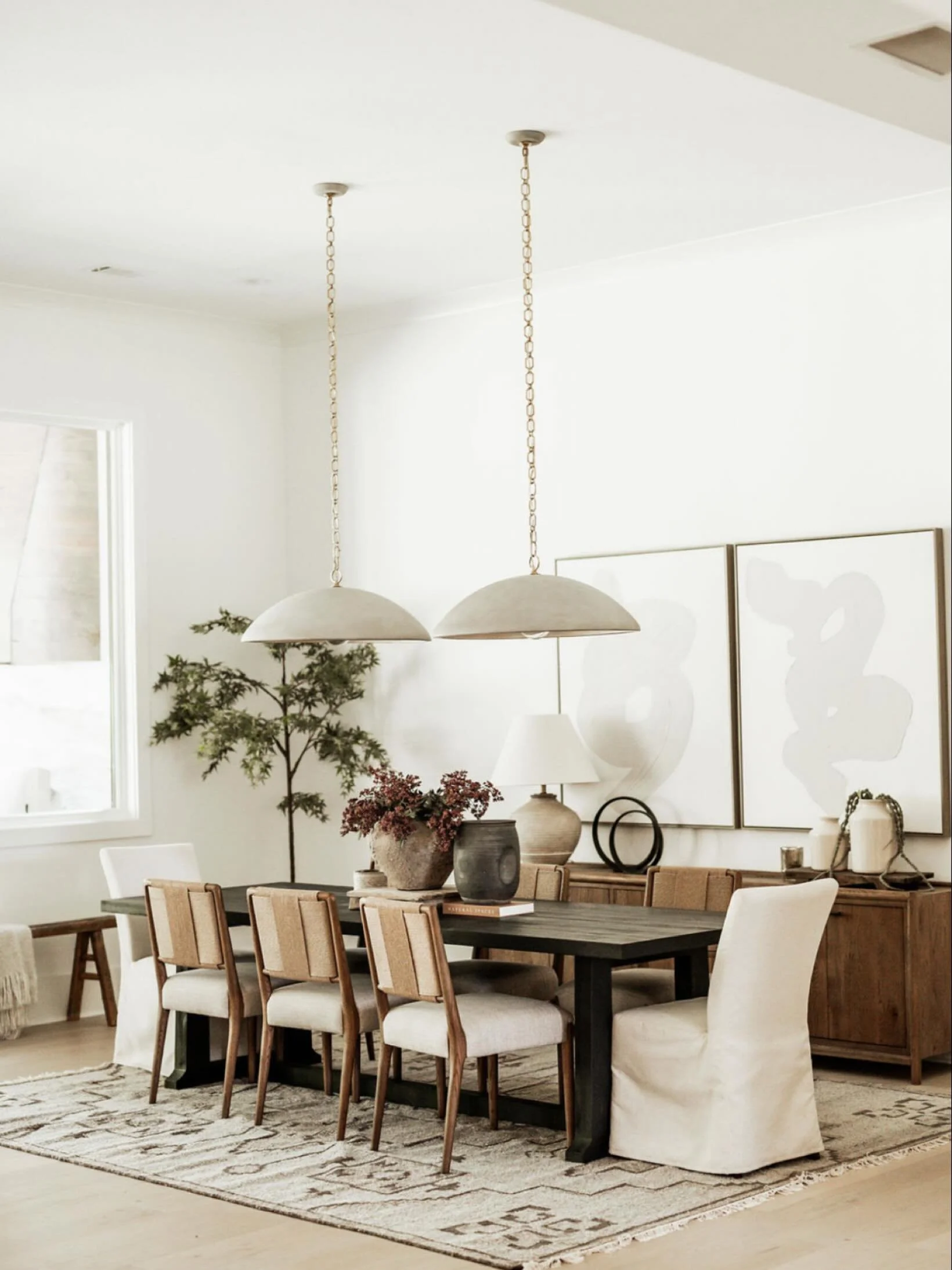 Every element in this space was designed to invite connection &mdash; the soft curves of the pendants, the warmth of the wood tones, and the balance of natural textures. ✨
It&rsquo;s the kind of dining room that feels elevated yet effortless &mdash; 