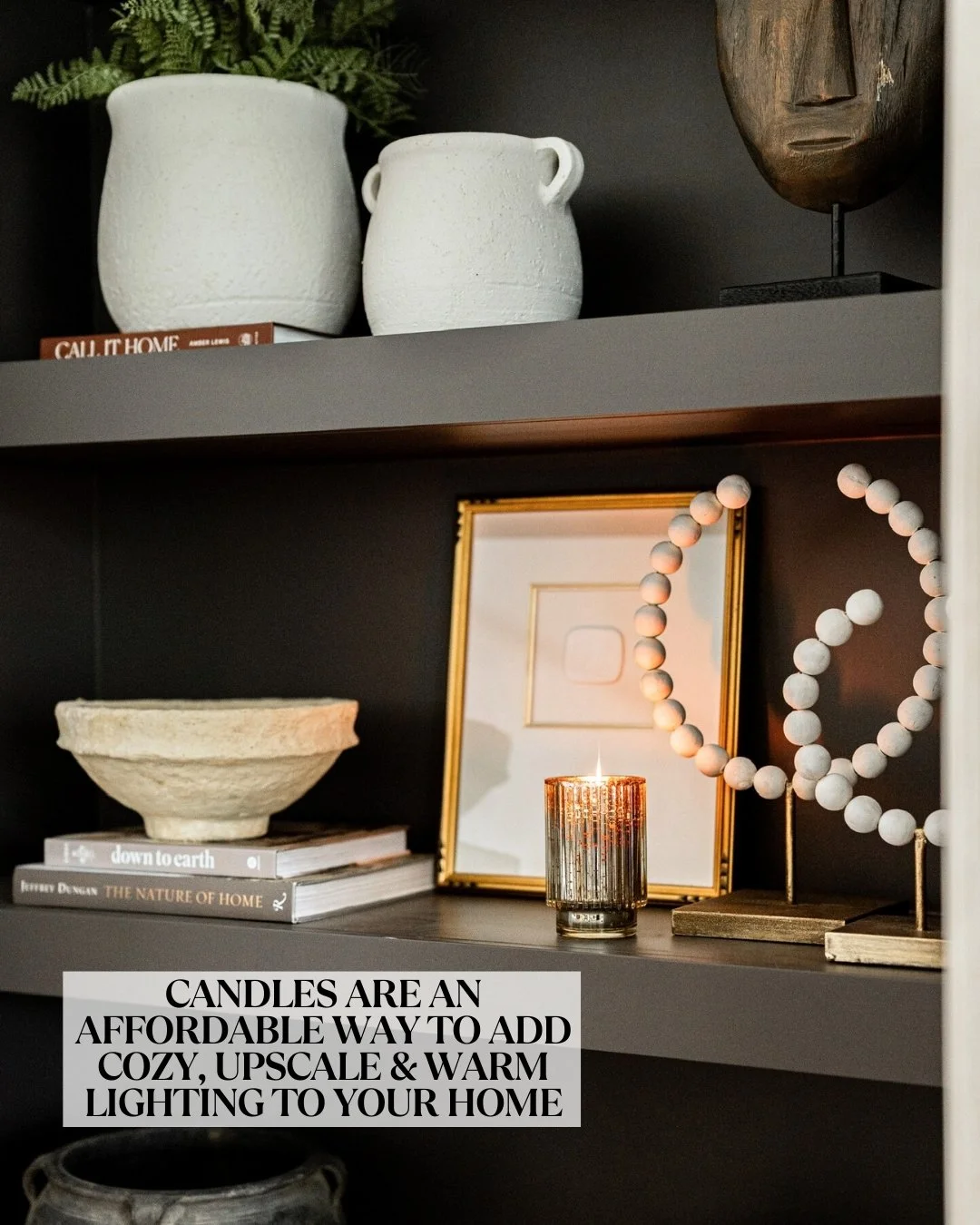black styled book shelves with candles and vases