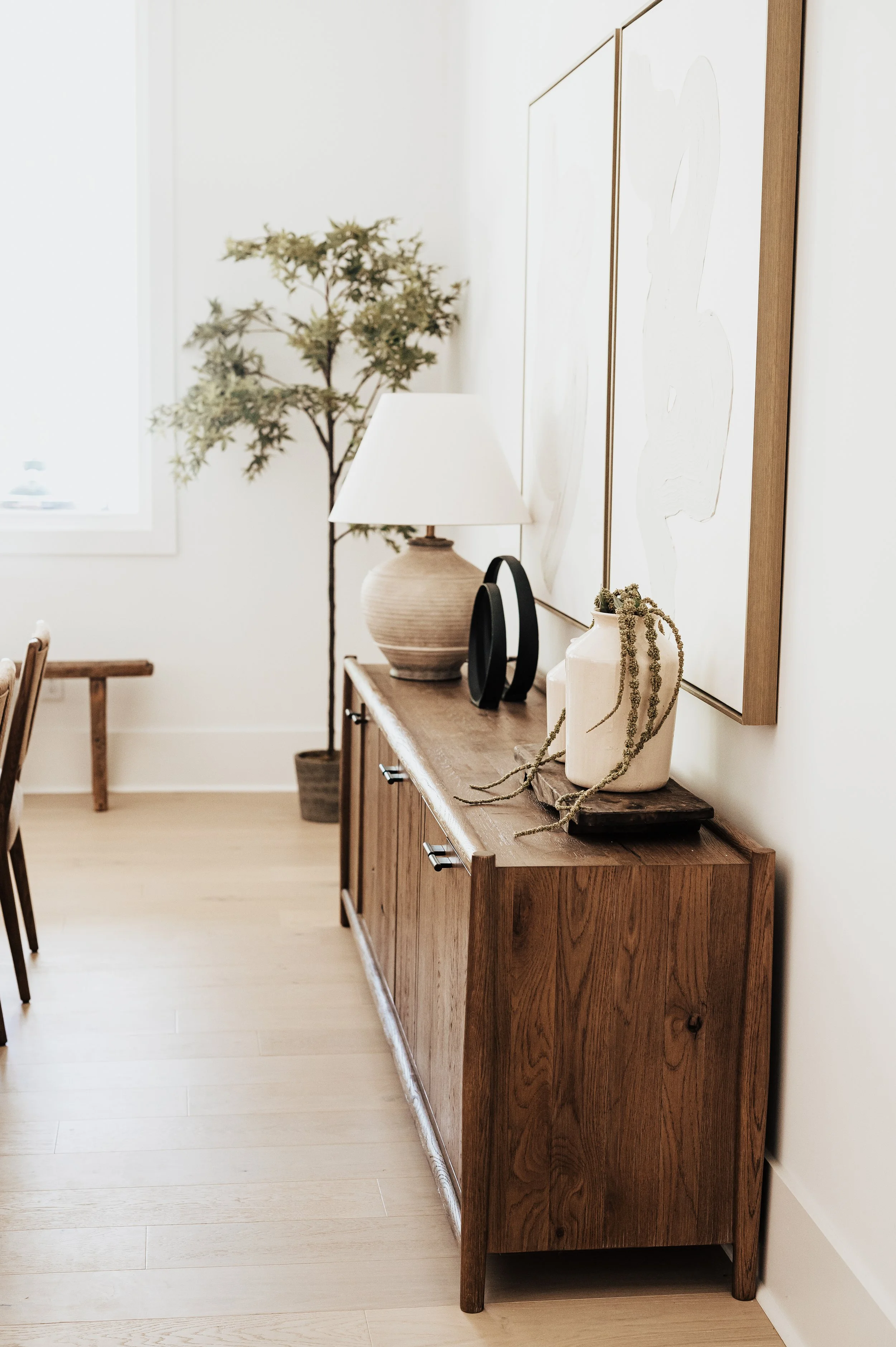 dining room console table with walnut table and lamp with a vase and stems