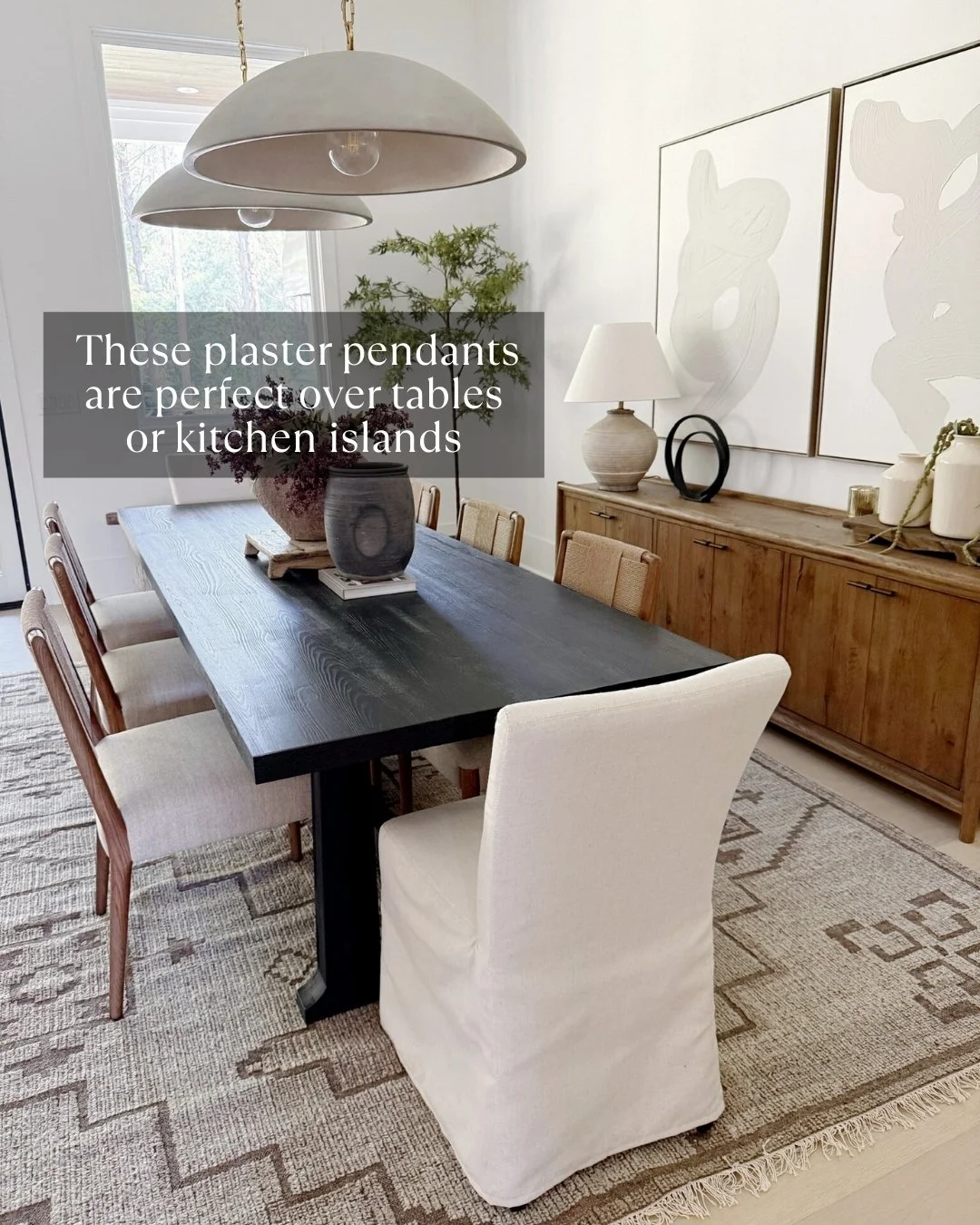 Modern dining room table with large cement pendants overhang