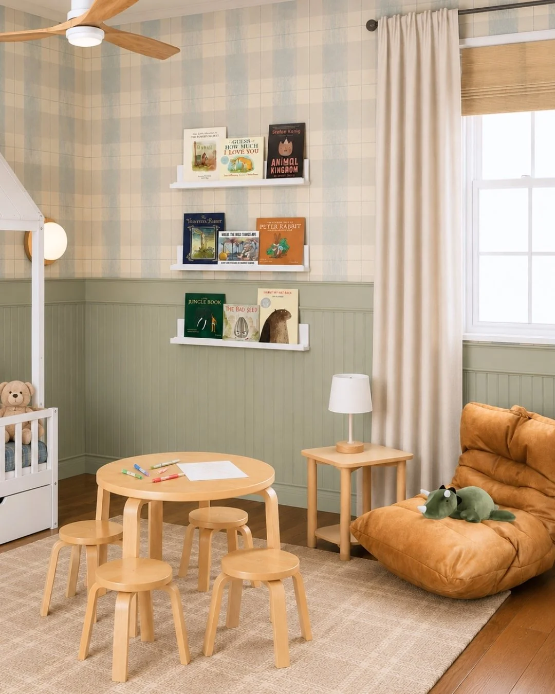 little boys bedroom with blue plaid wallpaper, and leather chair with floating bookshelves