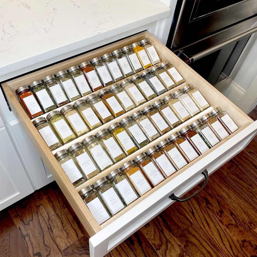 spice rack drawer with glass containers labeled and clean
