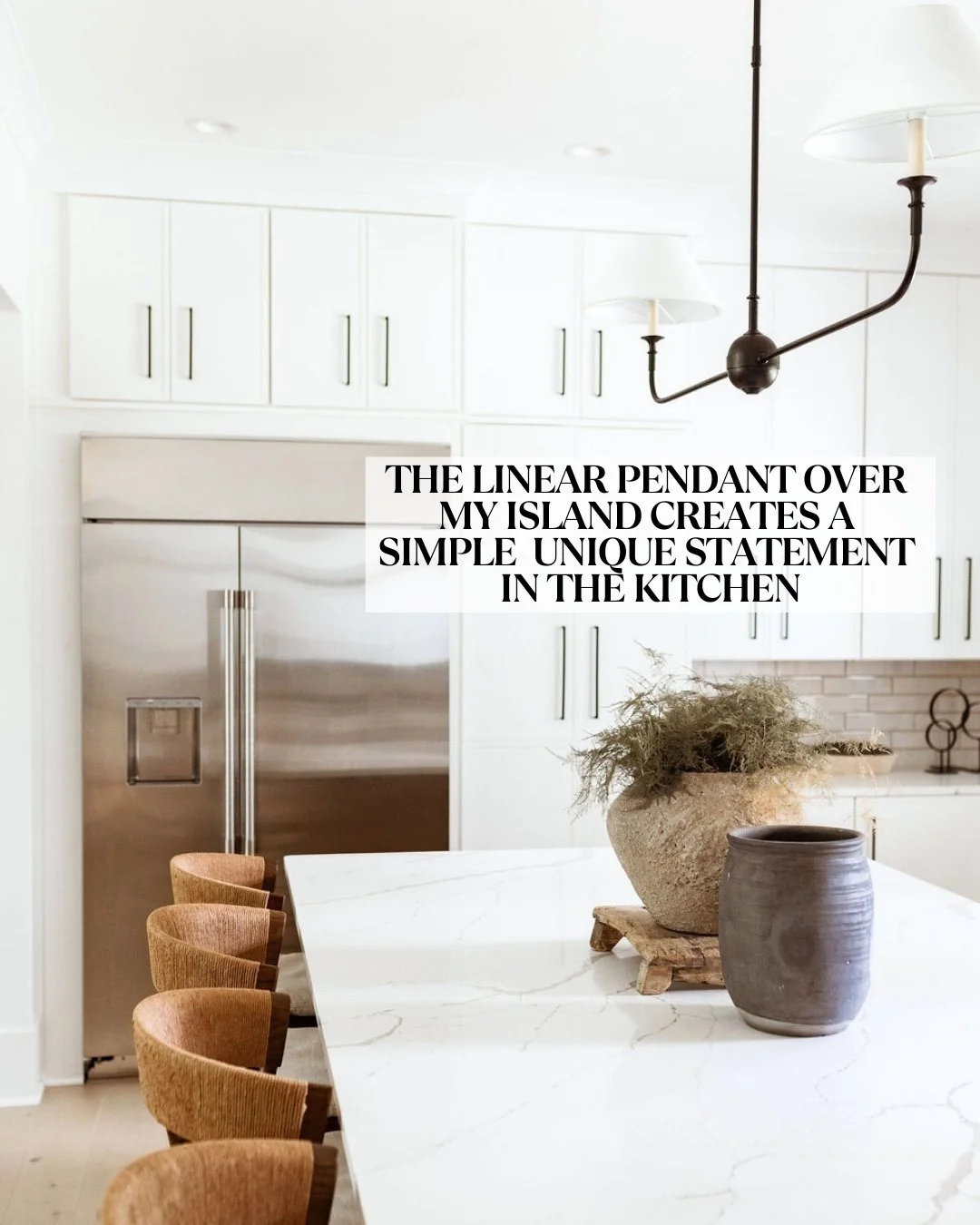 Neutral white kitchen with barstools and a metal modern pendant light