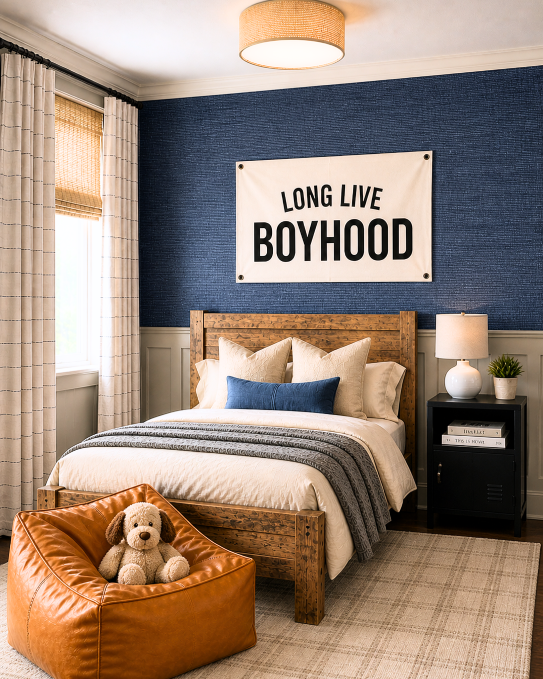 boys bedroom design with navy wallpaper, long live boyhood sign, and leather chair