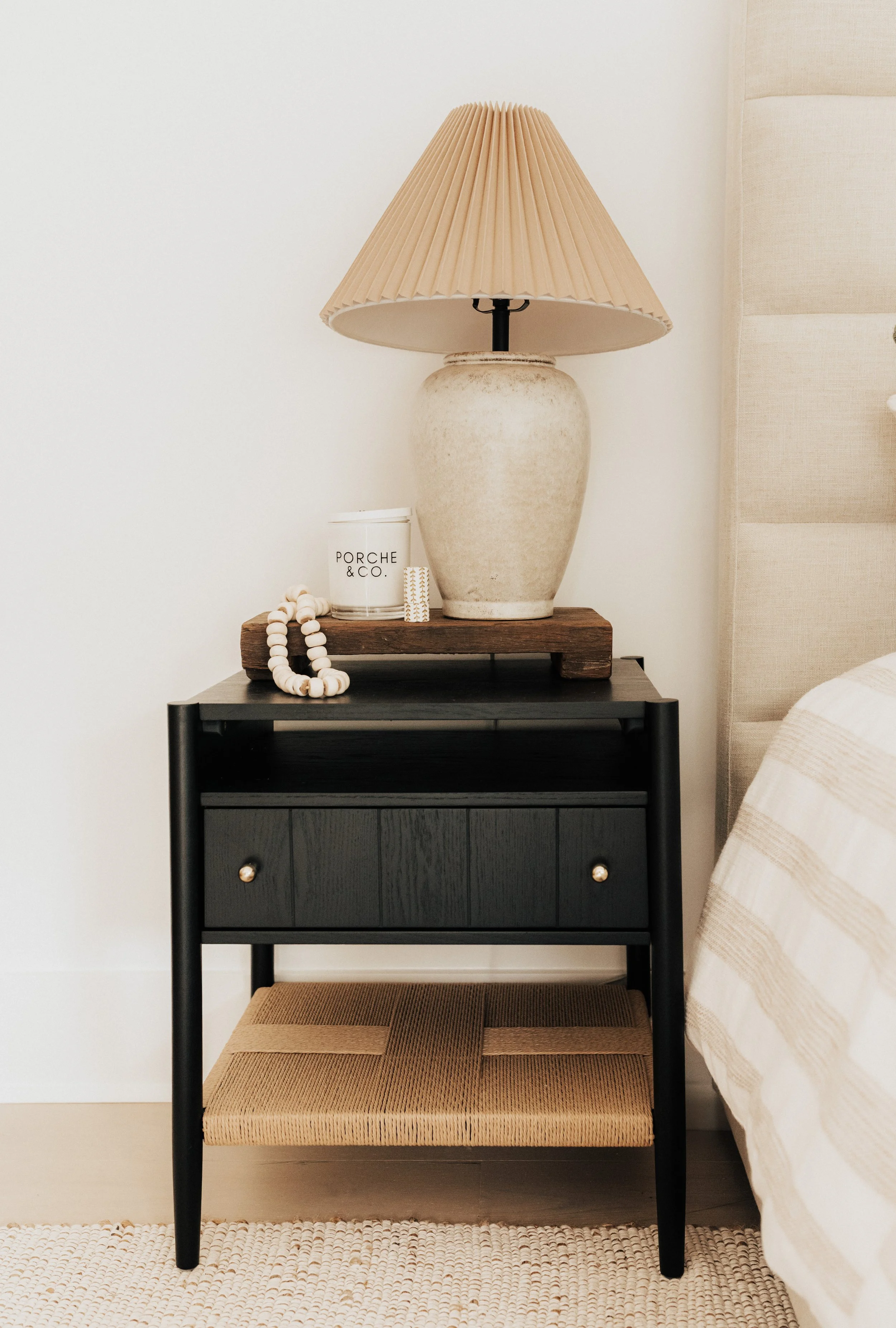 black nightstand with porche and co. candle