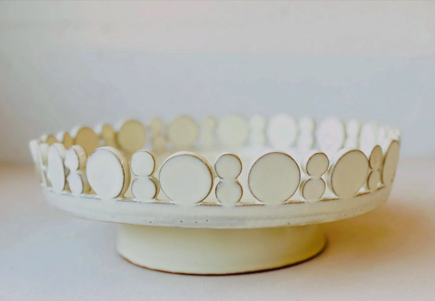 This is the best side of this piece.  Several technical issues with this one.  First it was hard to handle this piece without knocking off the circles, two of them were glued back on after bisque.  Second, there were multiple rounds of glaze testing 