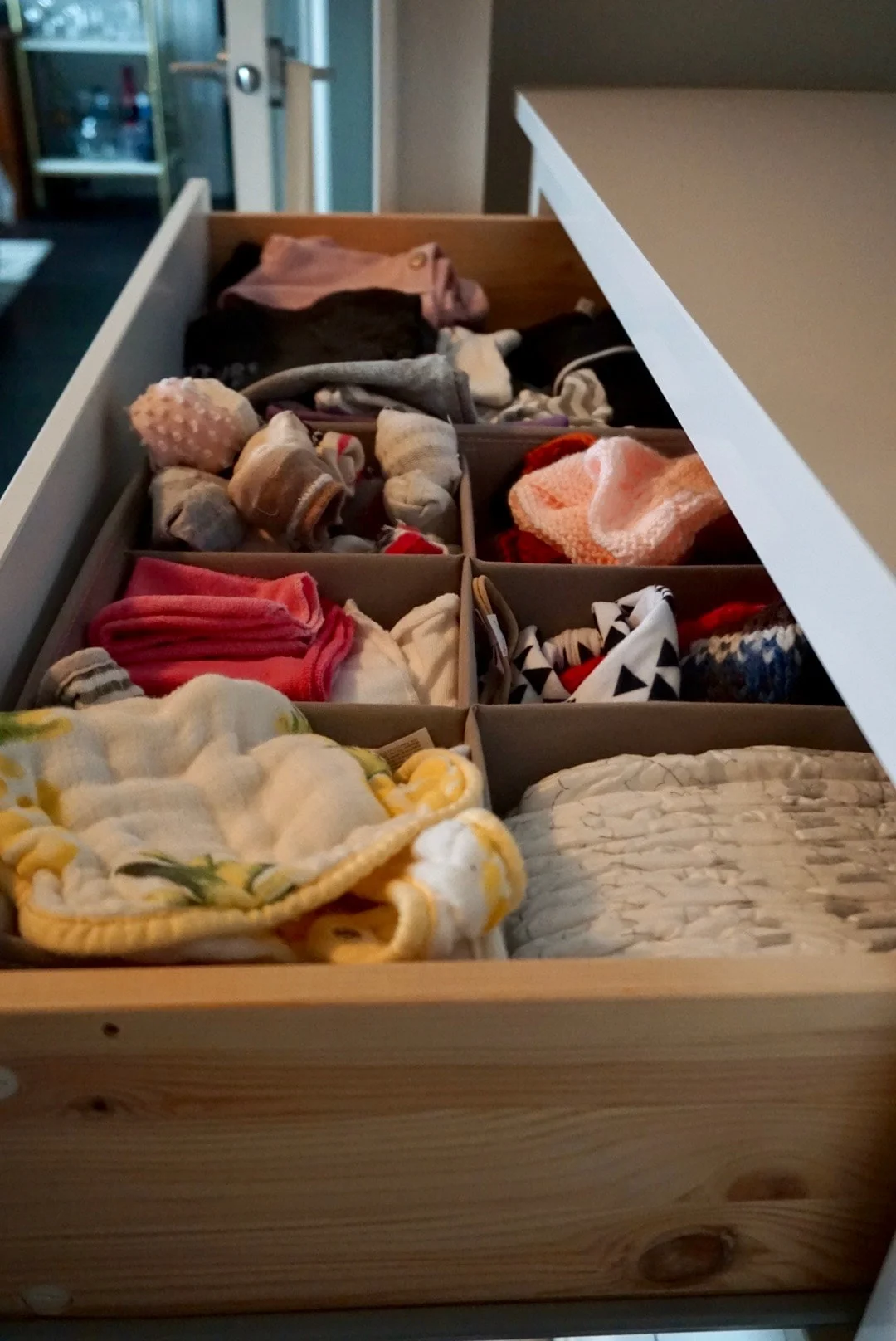 Everything in the first drawer has items for 6 to 12 months. The second drawer is 12 month+ clothing and we use the bottom drawer for storage purposes.