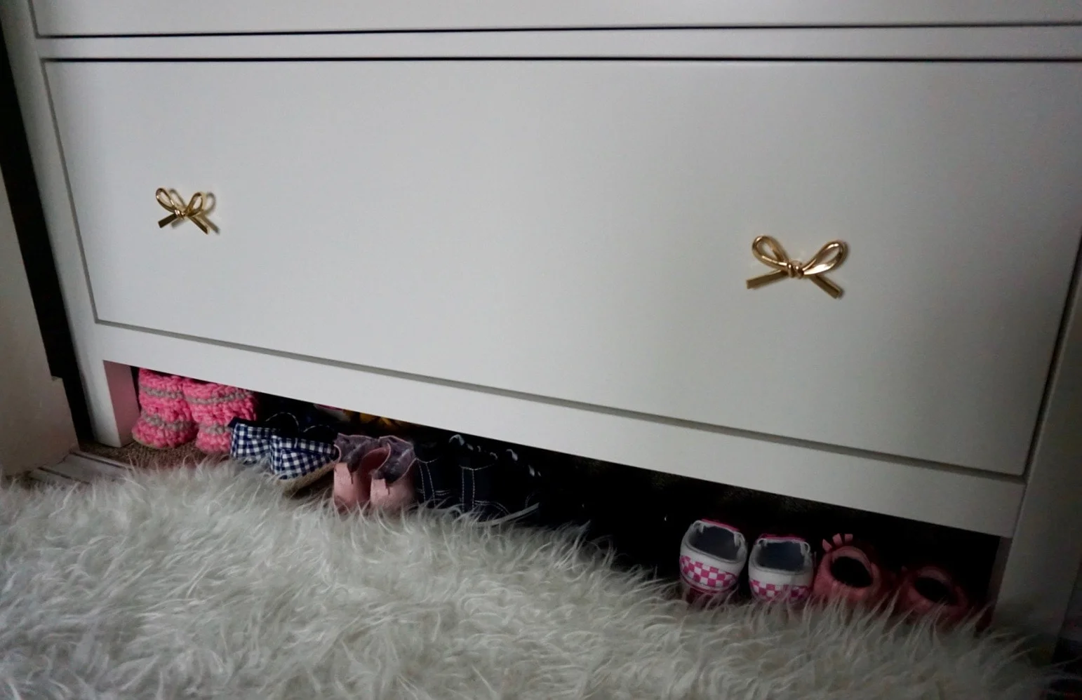 I keep Nora’s shoes underneath her dresser!