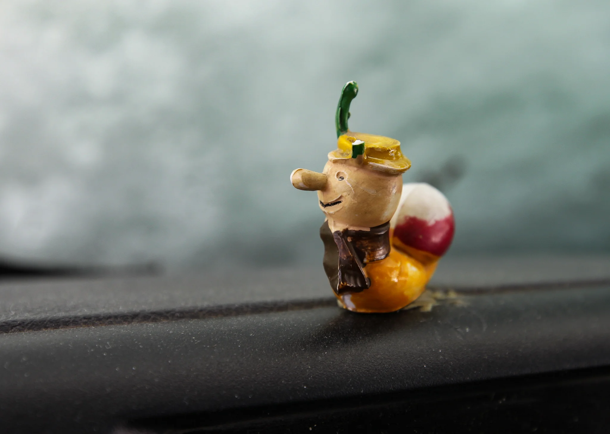 BRIAN THE SNAIL WATCHES THE WORLD FROM THE CAMPER’S DASHBOARD.