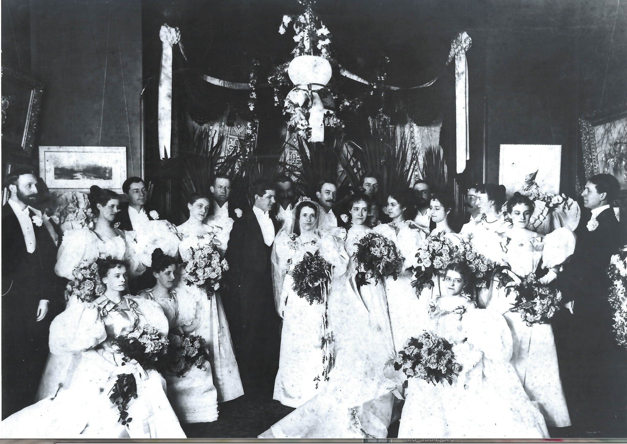 CAN YOU HELP WITH OUR MYSTERY PHOTO? This wedding photograph is an unusual image from our collection that caught our attention. Other than a date of 1920, no information is available regarding whose wedding this was or where it occurred. We would gre