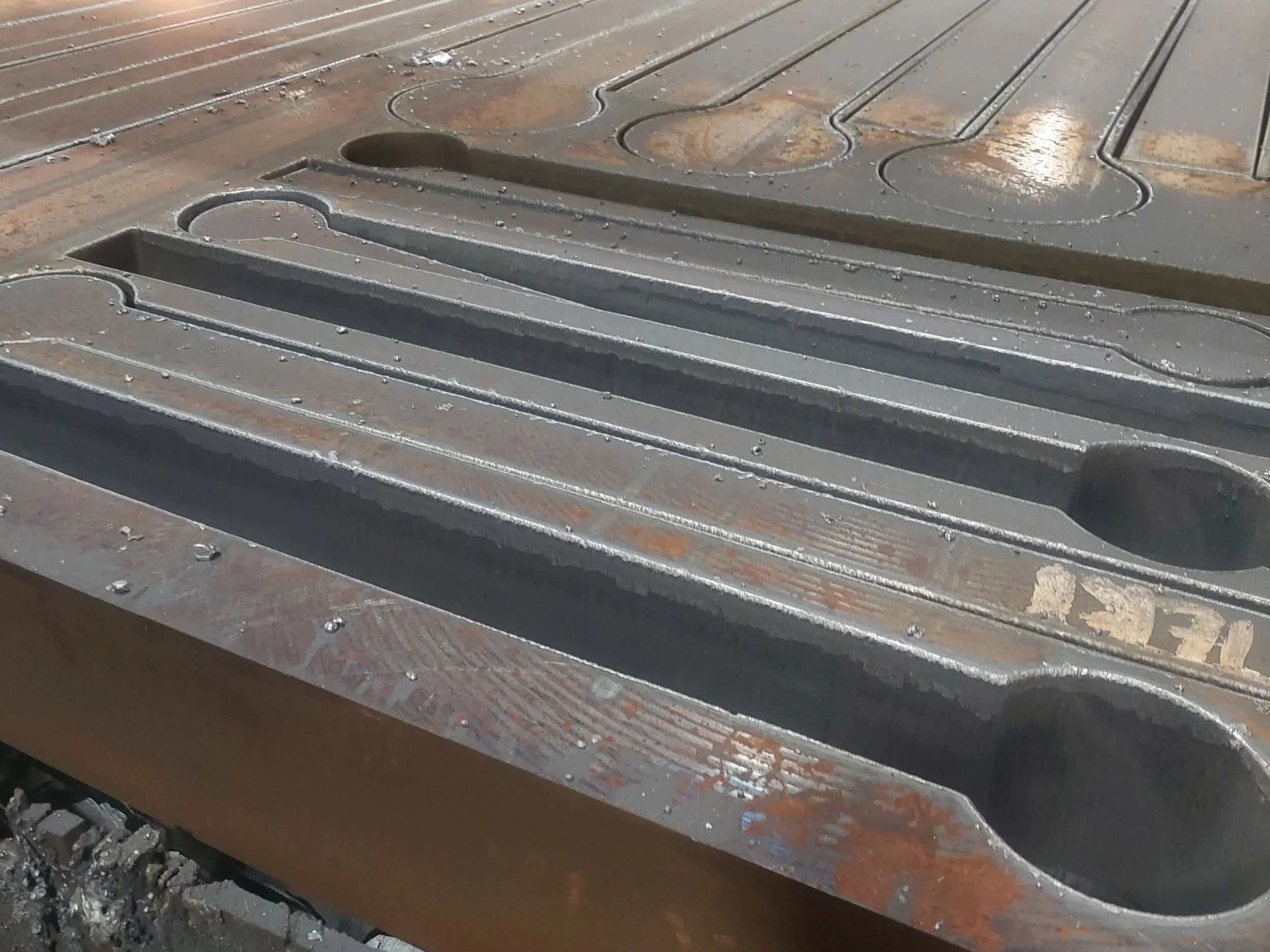 Custom-made Class D forged 5-inch thick master plates. The blanks were flame-cut 3/4 inch oversized from our net finished machined parts. Material: ASTM A668.