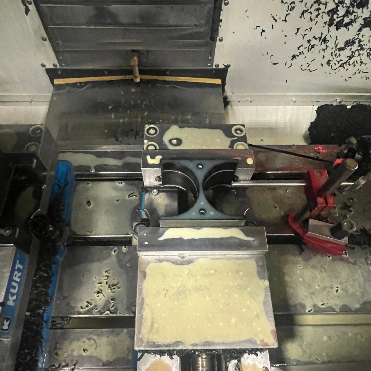 CNC-machined acetal component fixtured for a second machining operation.