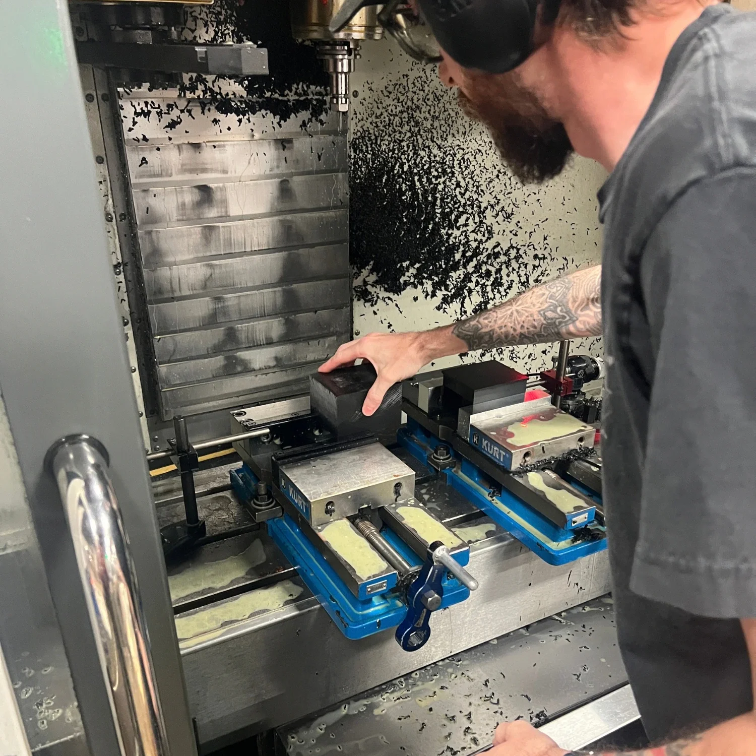 Acetal component secured in a vise fixture during CNC machining.