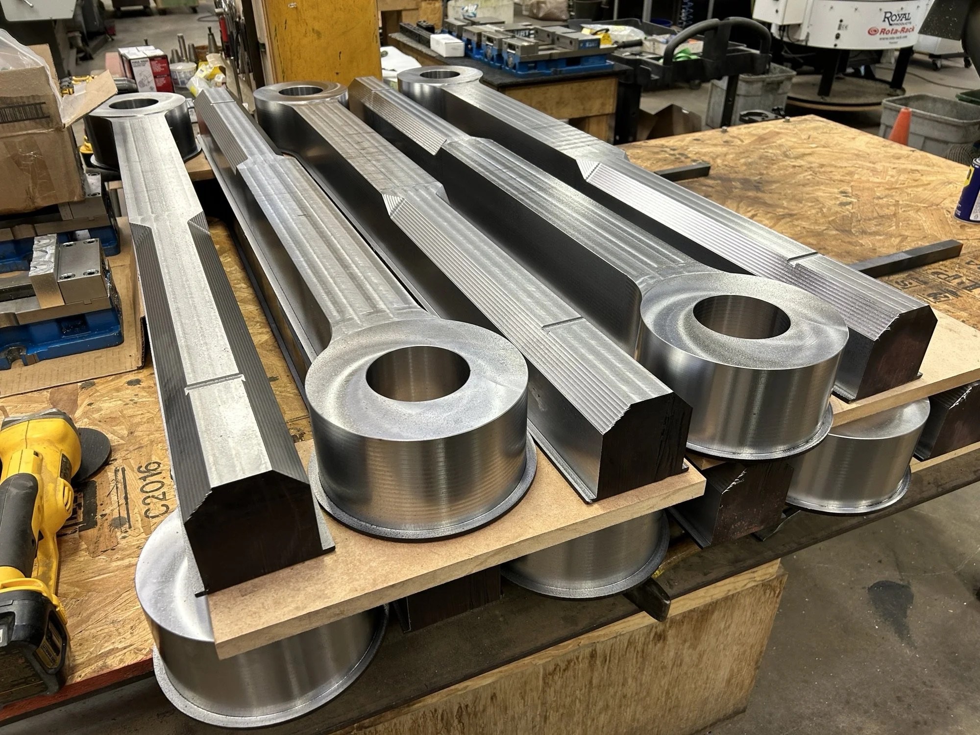 What the parts looked like after the first and second operations. The corners of the bolt blanks were machined down to reduce the challenge of turning the 3 3/4 inch acme thread and the slot on the top was a reference for the overall length of the bo